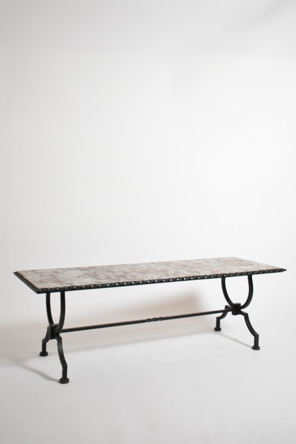Wrought iron and marble coffee table, France 1940s — angled view on white background