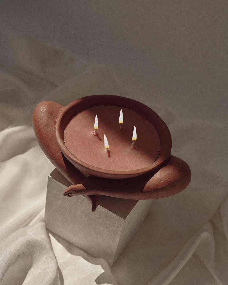 Contemporary Sculptural Candle in Resin and Stone – Tobacco by Marcela Cure — close-up of candle on soft fabric background