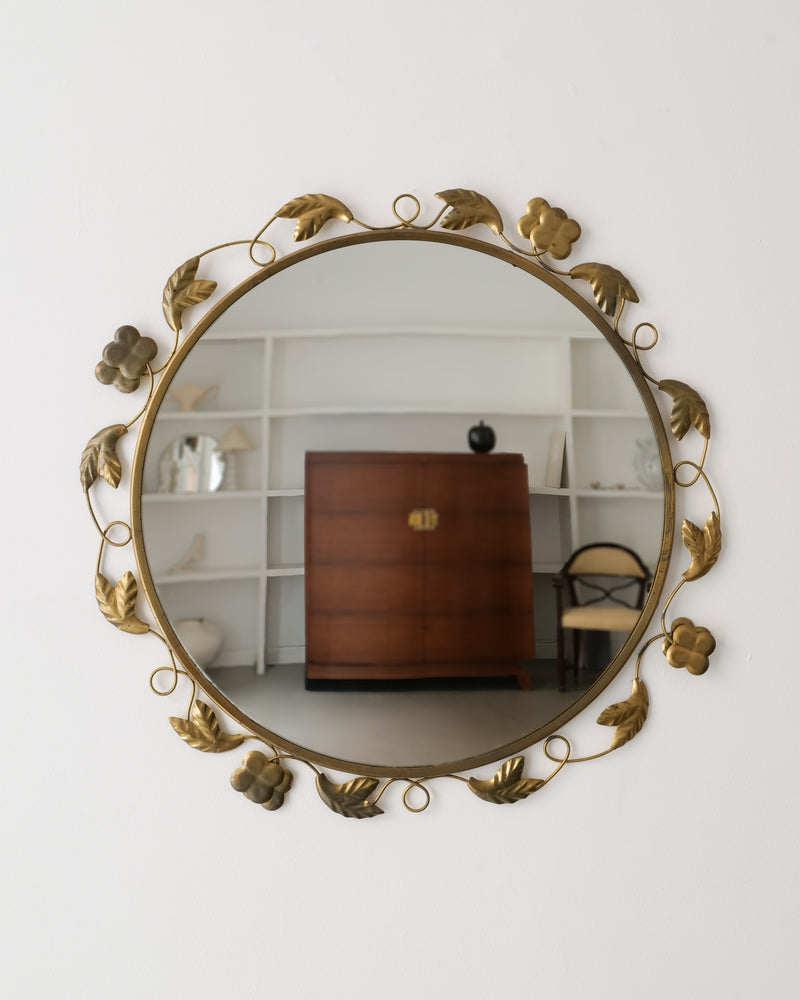 The Swedish Modern Brass Mirror 1940s by Collection apart features a round gold leaf and floral brass frame, reflecting stylish minimal decor. Add a touch of 1940s elegance to any modern space.