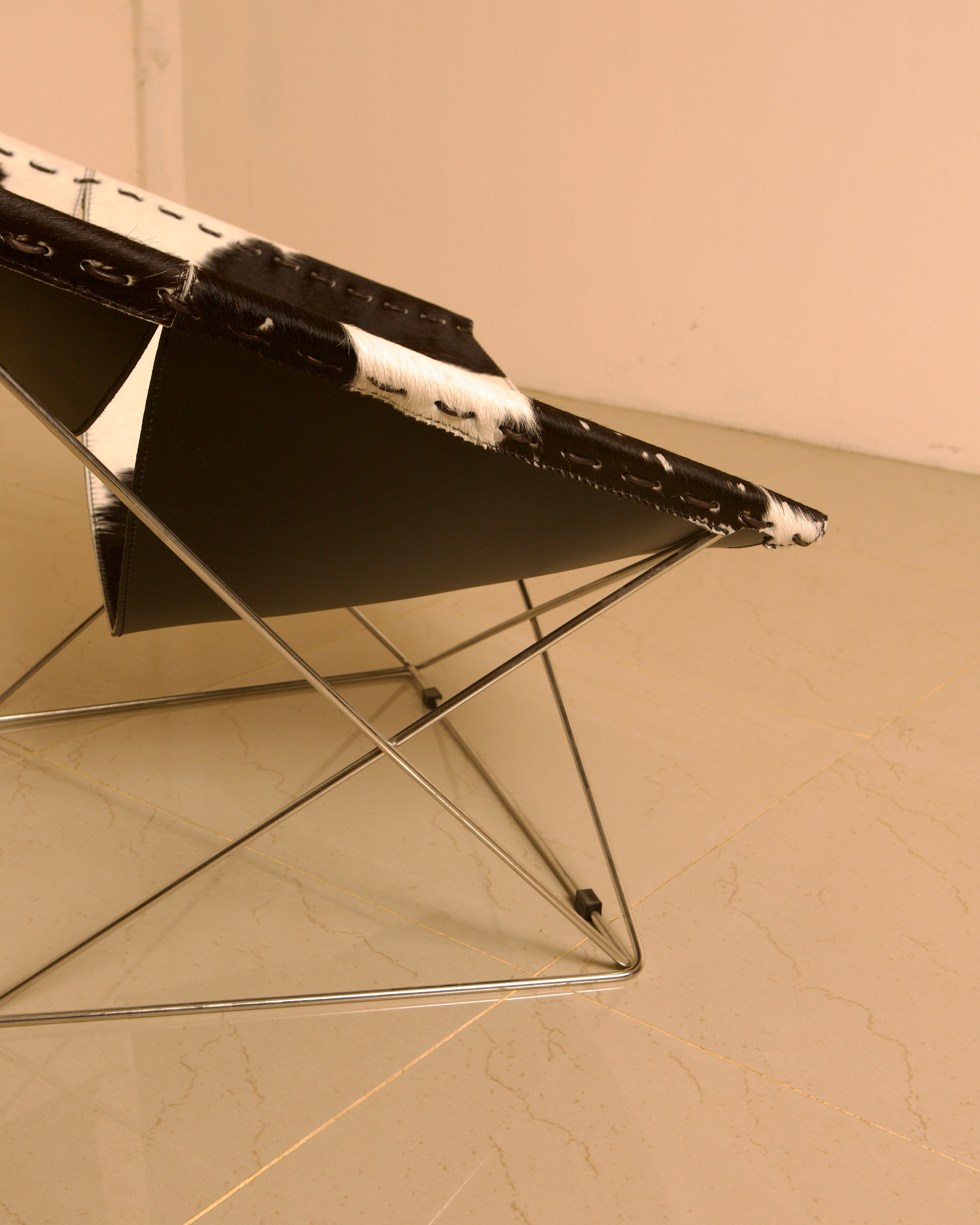 F675 "Butterfly" Cowhide Armchair by Pierre Paulin for Artifort 00's — angled view highlighting cowhide material and chrome l