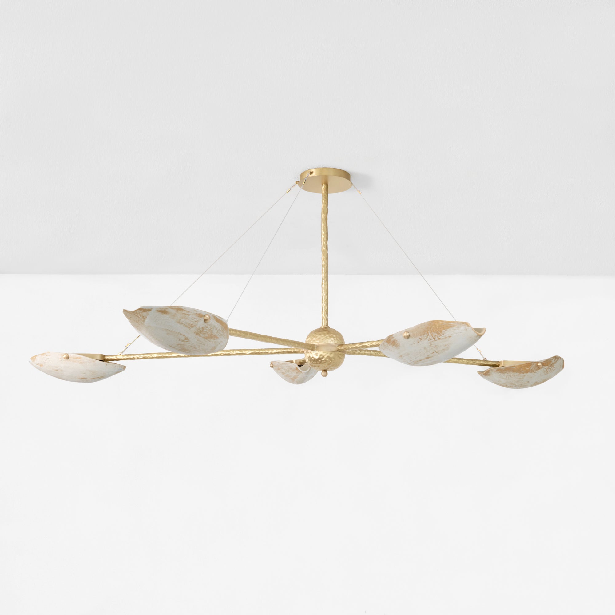 Serrallés Chandelier — close-up of gold metal arms with white shades