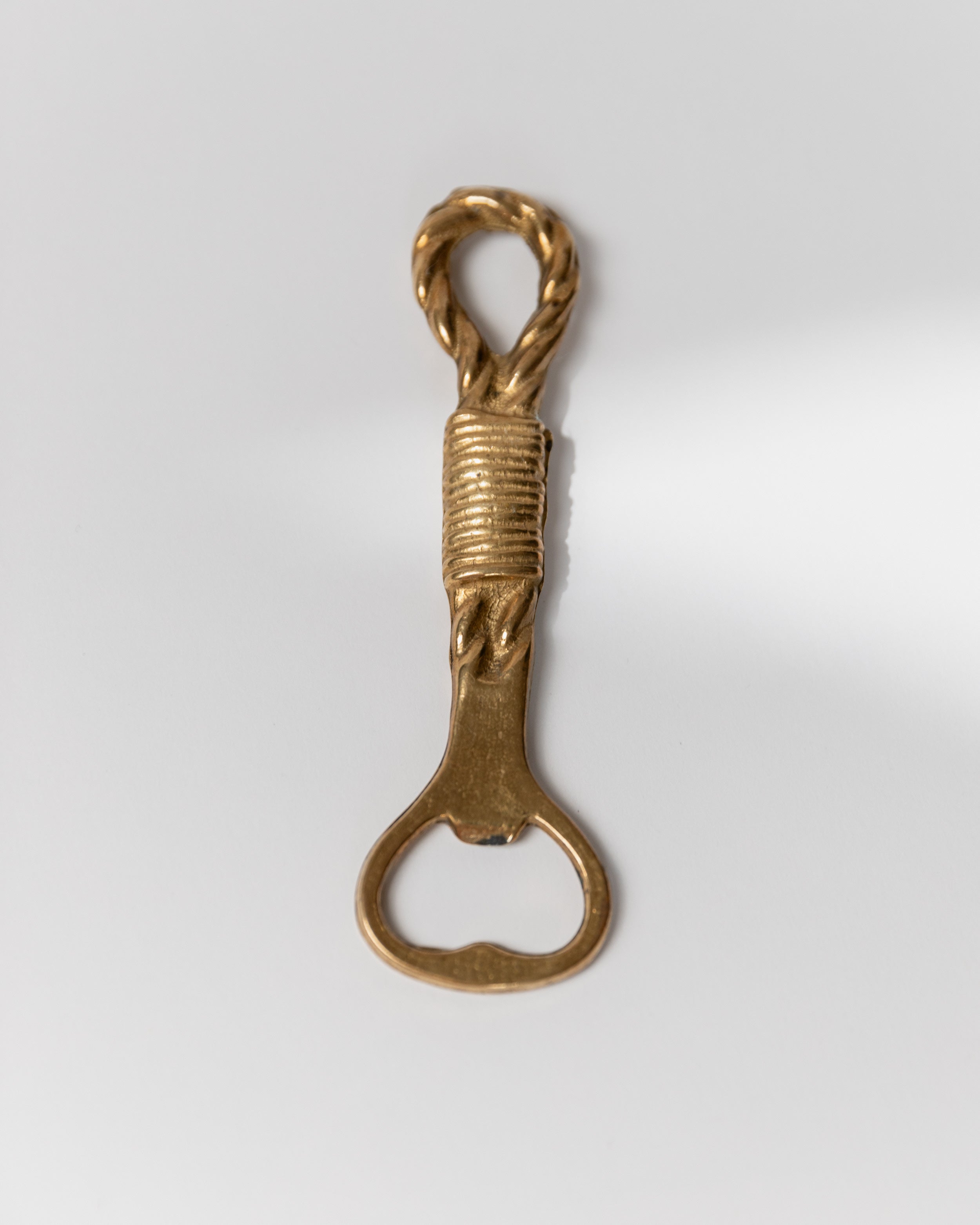 Vintage brass bottle opener with twisted rope handle detail