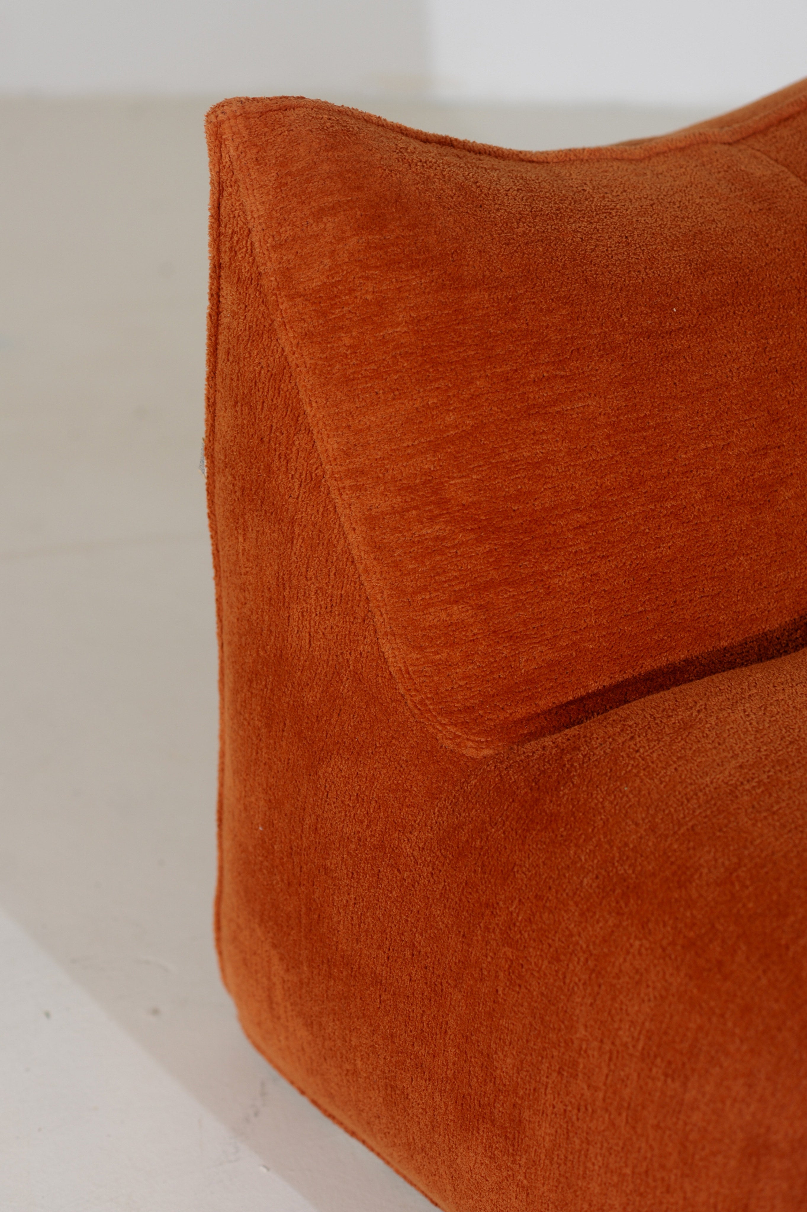 Orange Le Bambole armchair detail showing curved upholstered form