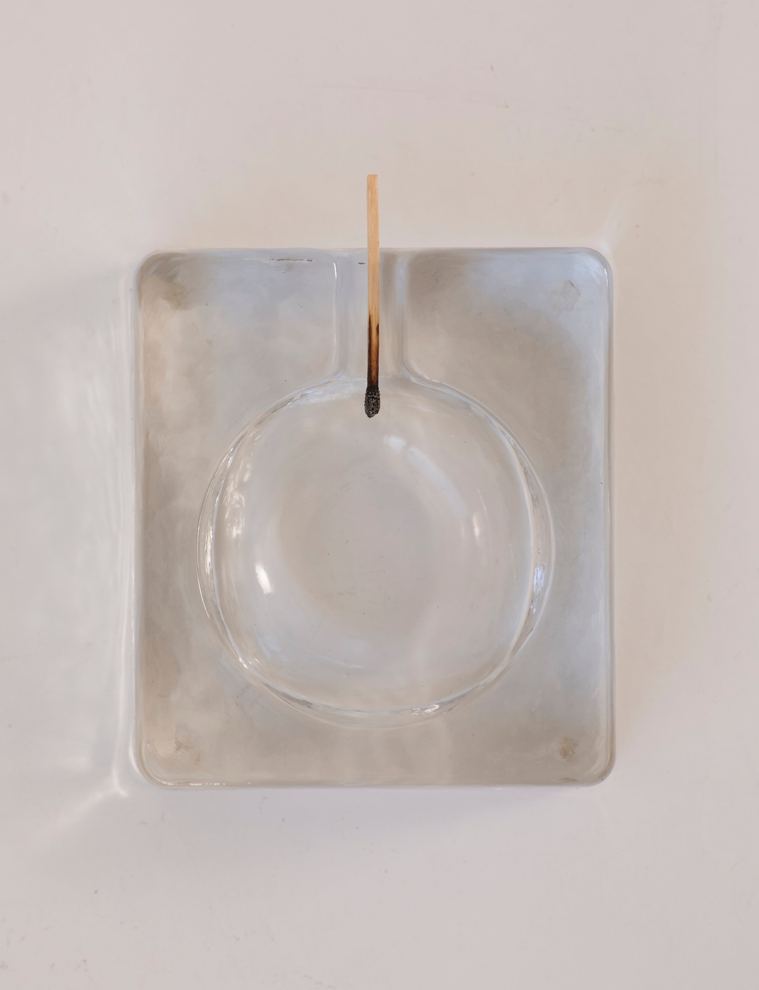 Scandinavian Clear Ashtray in Glass — top view on white surface
