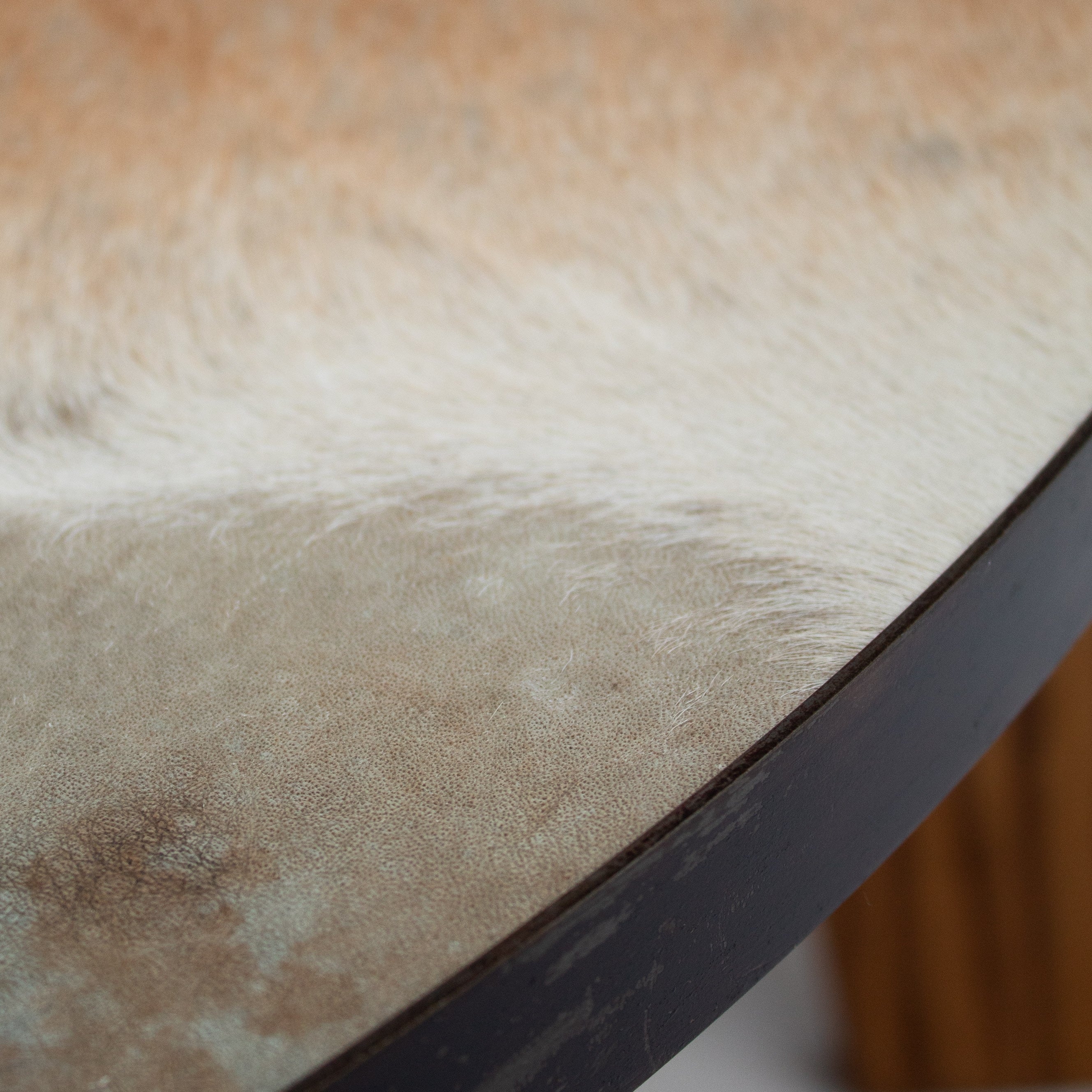 2 Coffee Tables in Wood and Cowhide — close-up of cowhide texture detail