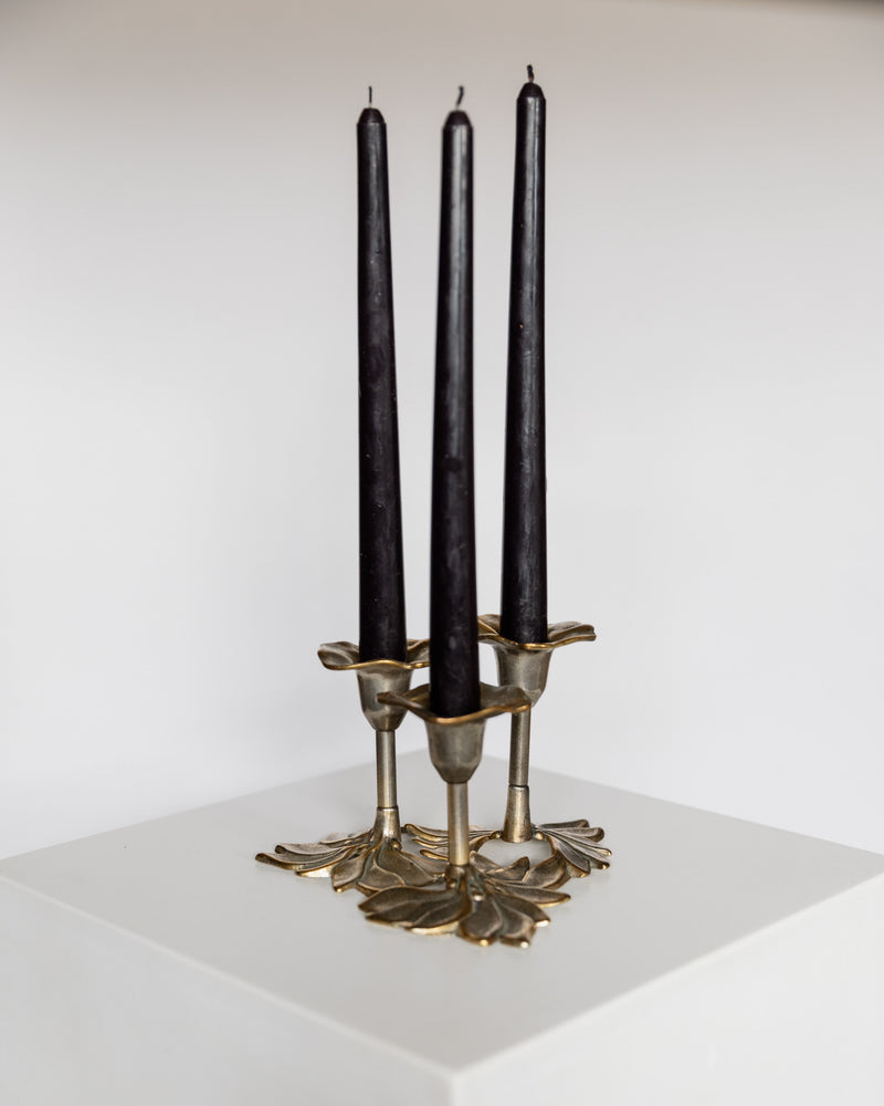 Brass lotus-leaf candelabra by Carl Frederik Christiansen with black tapered candles