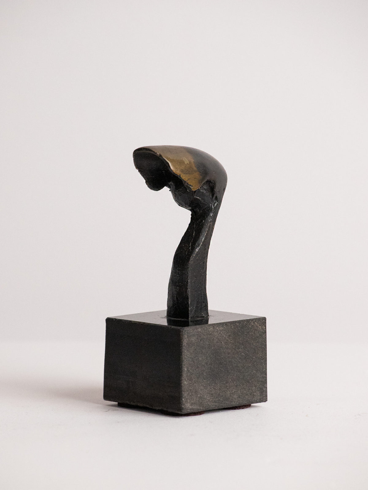 Biomorphic Sculpture in Patinated Metal on a Black Stone Cube, Scandinavian, Late 20th Century — lifestyle setting