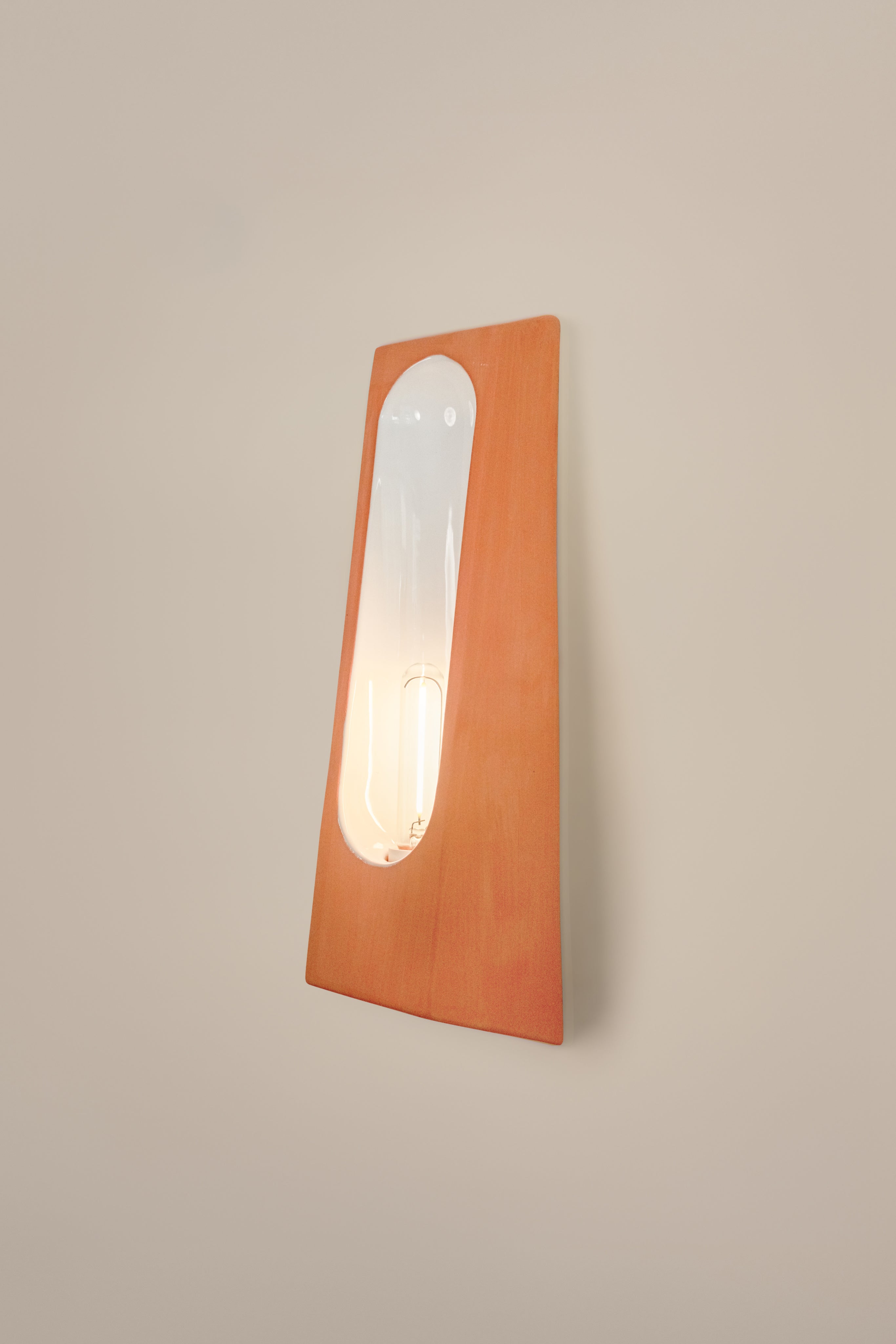 Alcove Terra B Mat — close-up of terracotta wall lamp with glass bulb