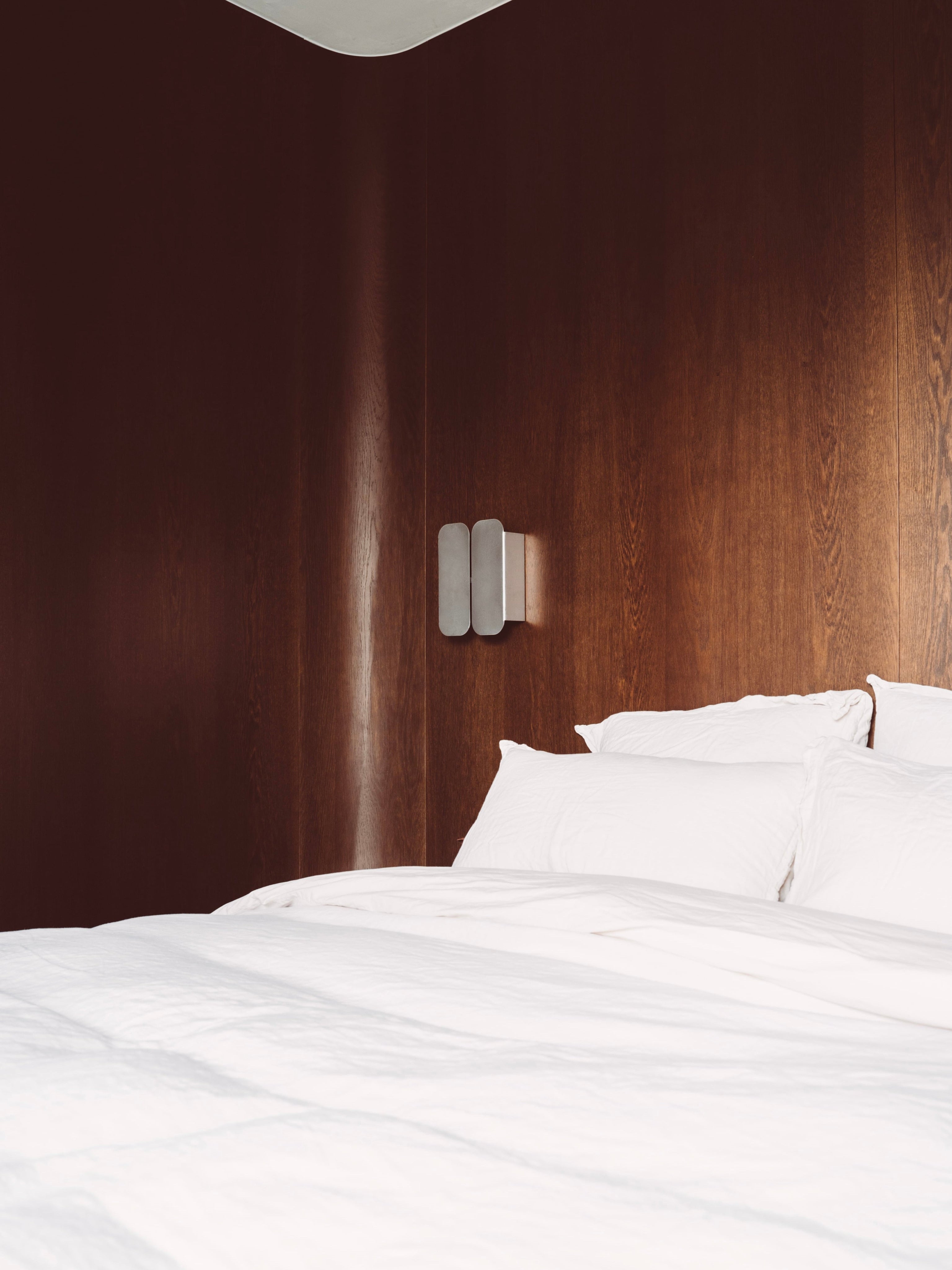 Wall Lamp - 1.0 - Double -Stainless Steel — mounted on wooden wall above bed