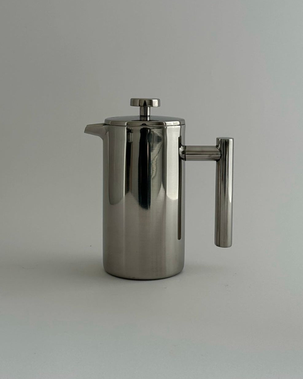 HEDONISM' stainless steel french press — close-up of polished surface and handle
