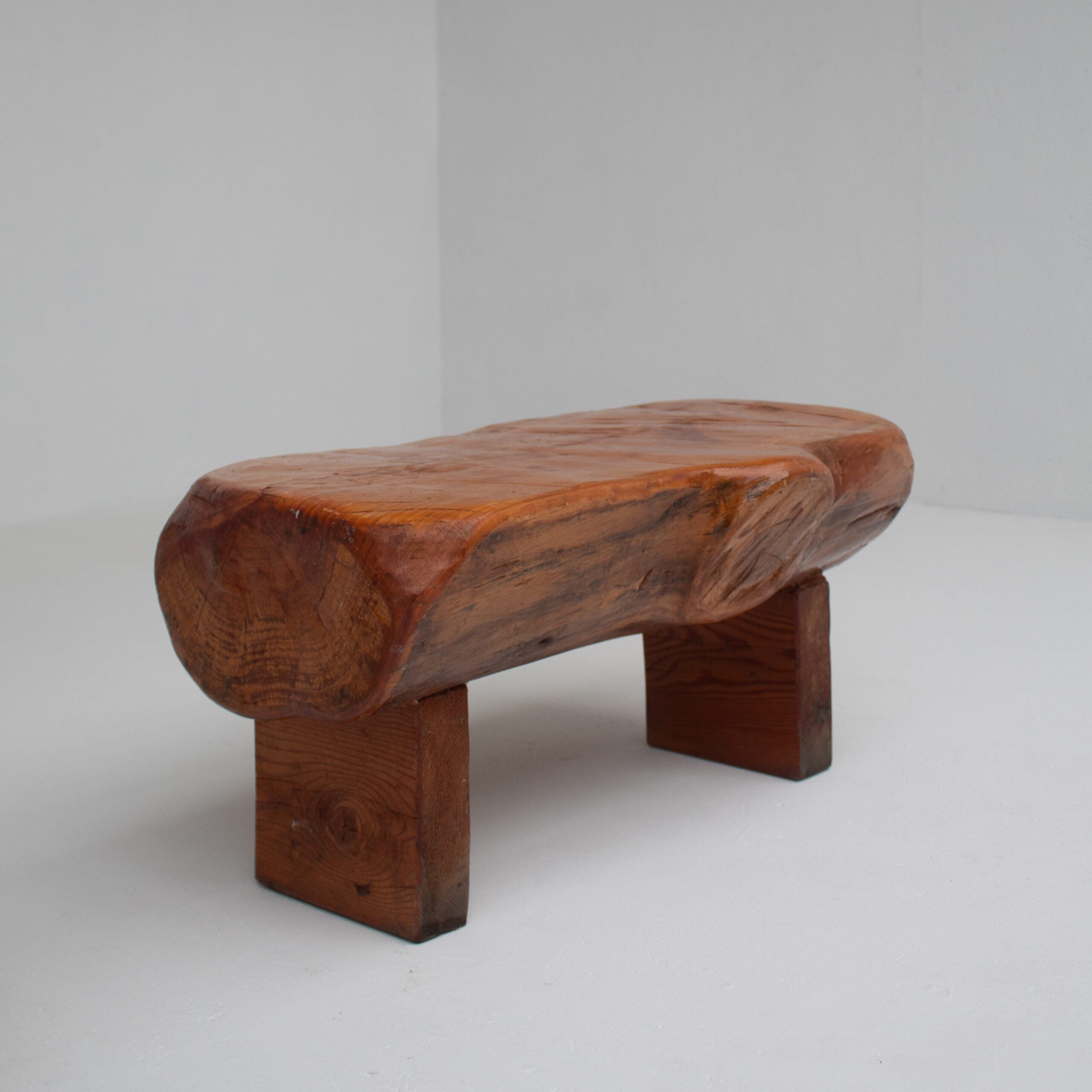 Pair of Rustic Wooden Sculptural Benches in Solid Wood — angled view on white background