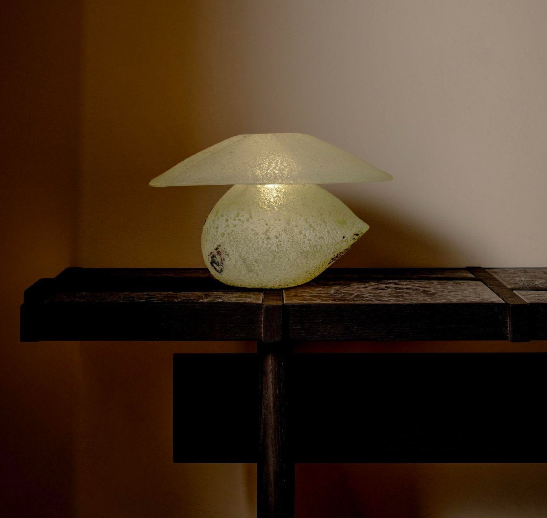 The Scavo Lamp — illuminated glass design on wooden table