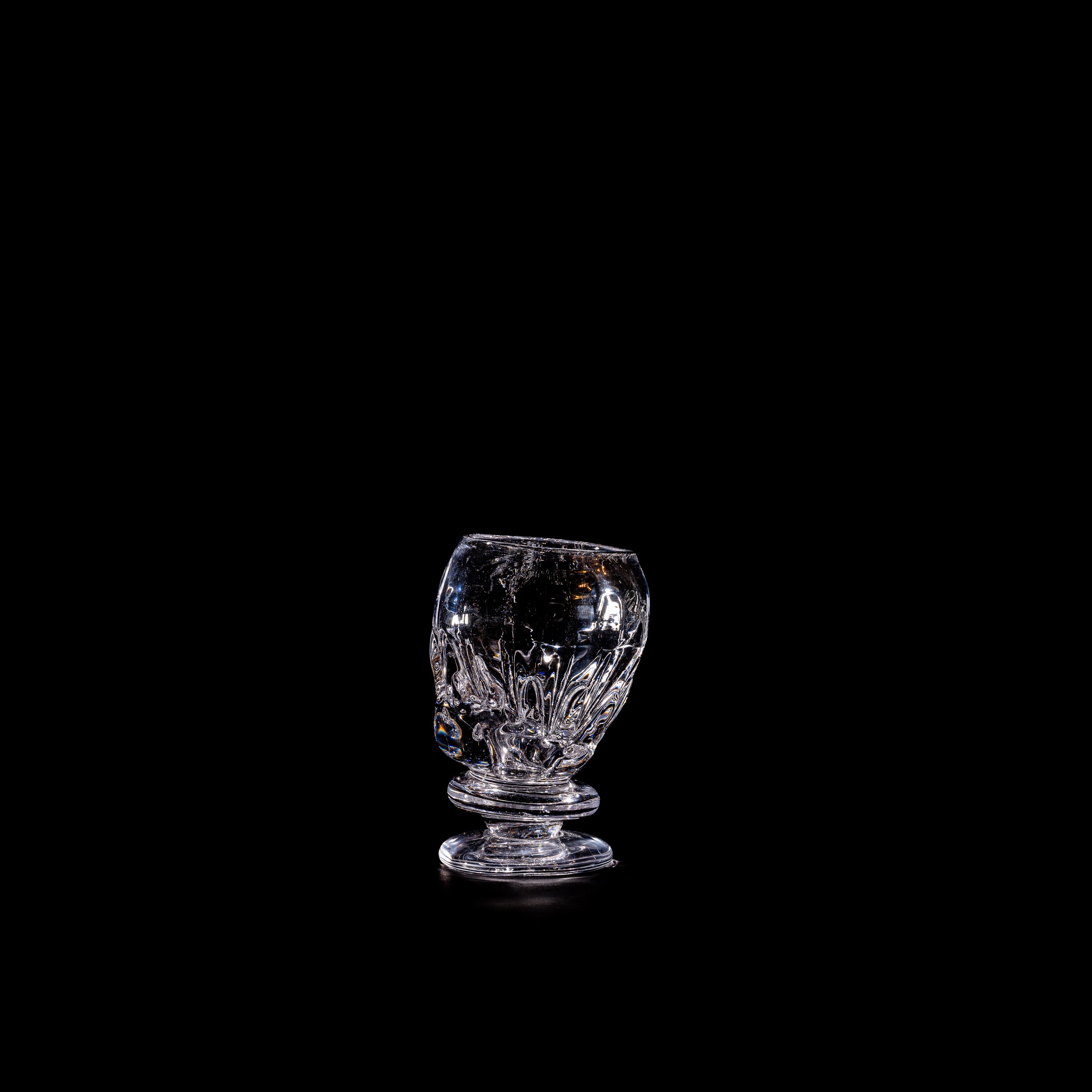 Round Free-shaped Glass — top view on black background