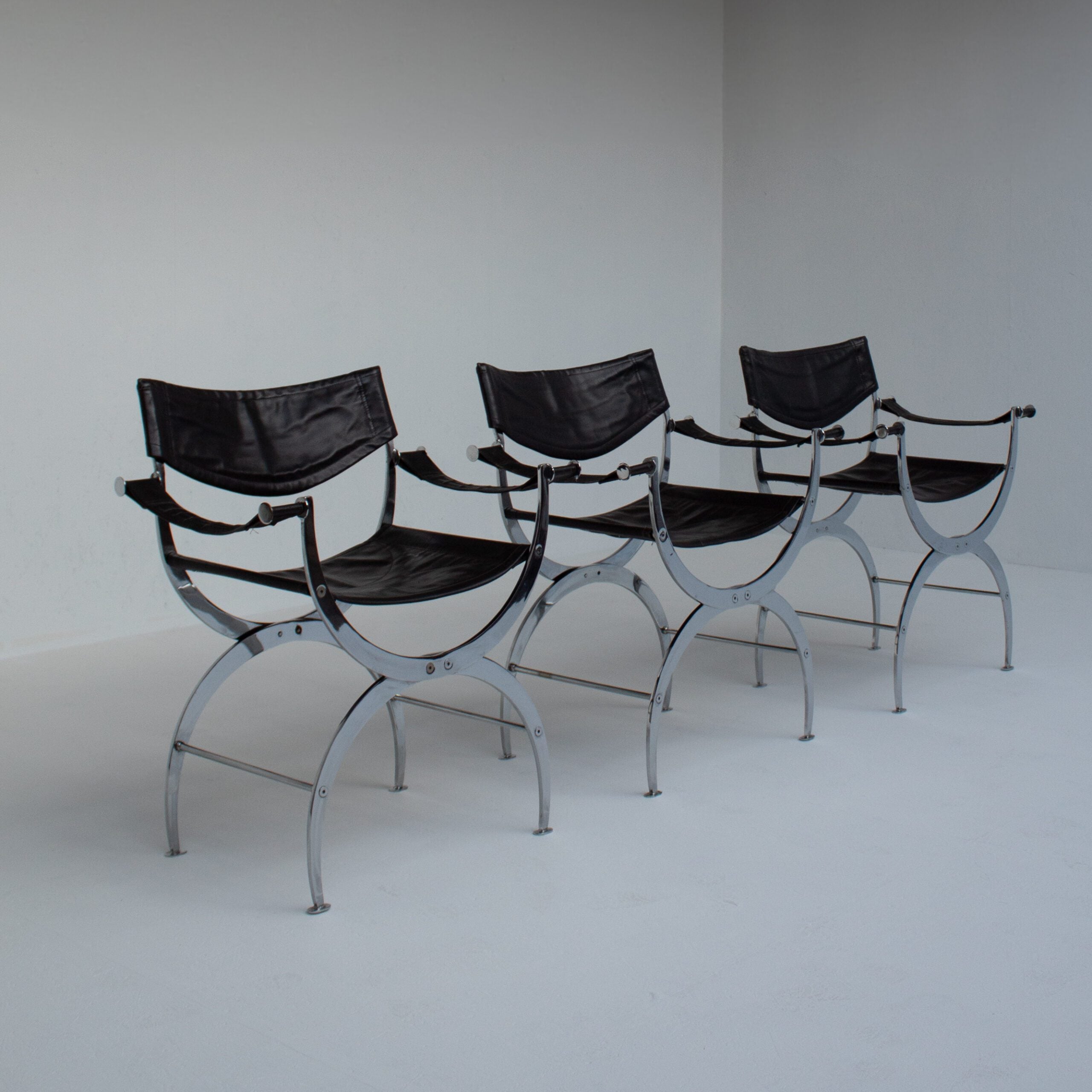 Set of 6 Italian Chrome Dining Chairs with Leather Seating — side view showing chrome frame and black leather seats