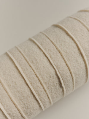 Textured wool bolster cushion — detail view
