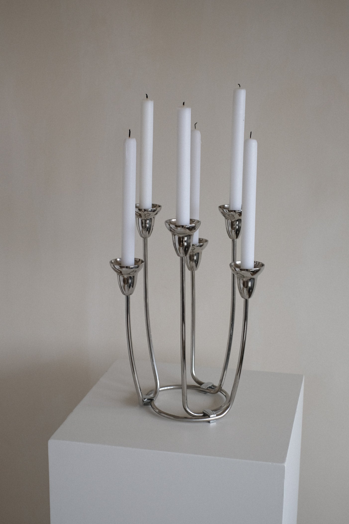 Large Candleholder — side view of polished metal design on pedestal