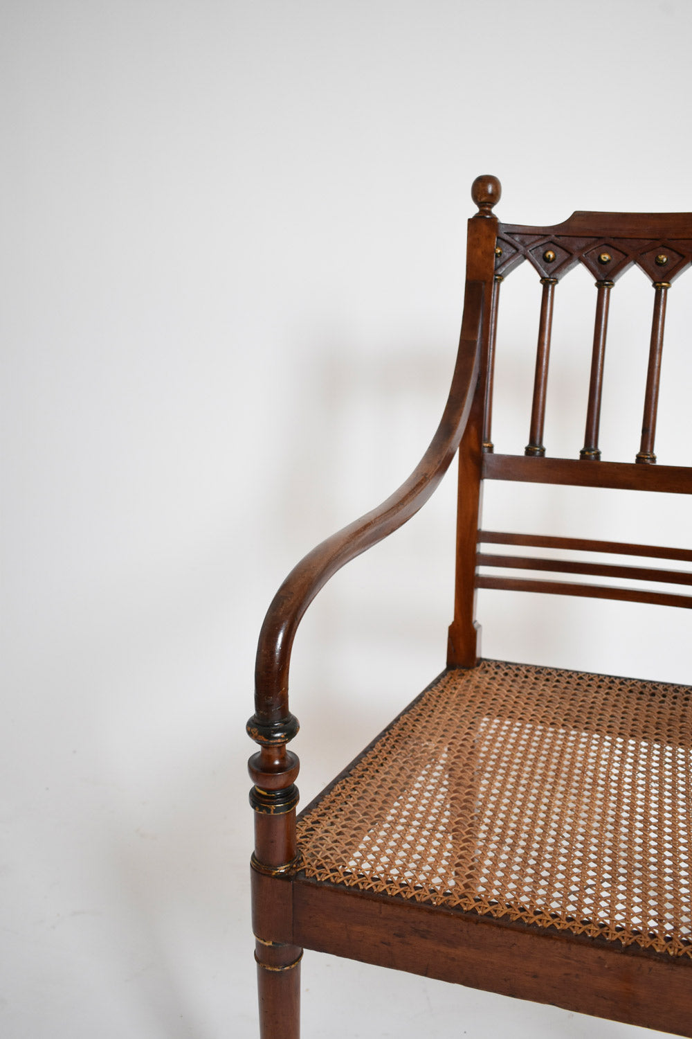 Pair of George III style armchairs, XIXth c. — close-up of caned seat and wooden armrest