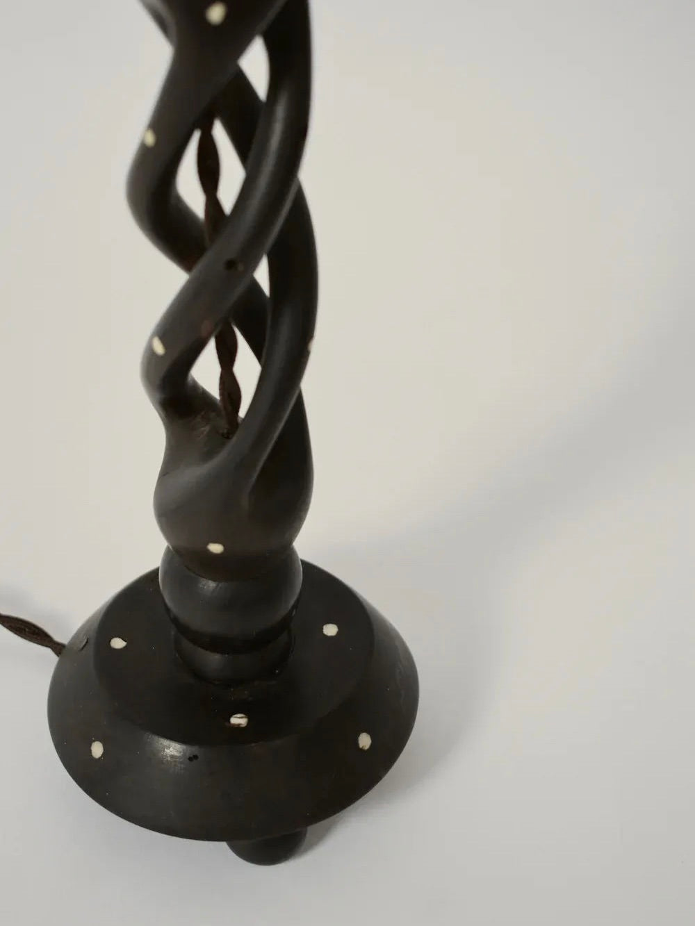 A close-up of the Barracuda Interiors Turned Wood Twist Lamp, 1960s, features a twisted wood base with small white dot accents, set against a plain light background. A partially visible brown cord is also shown.