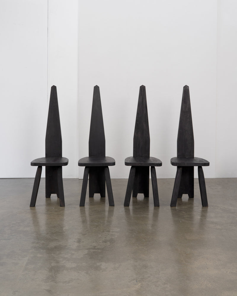 Brutalist High Back Chair — front view of four black wooden chairs