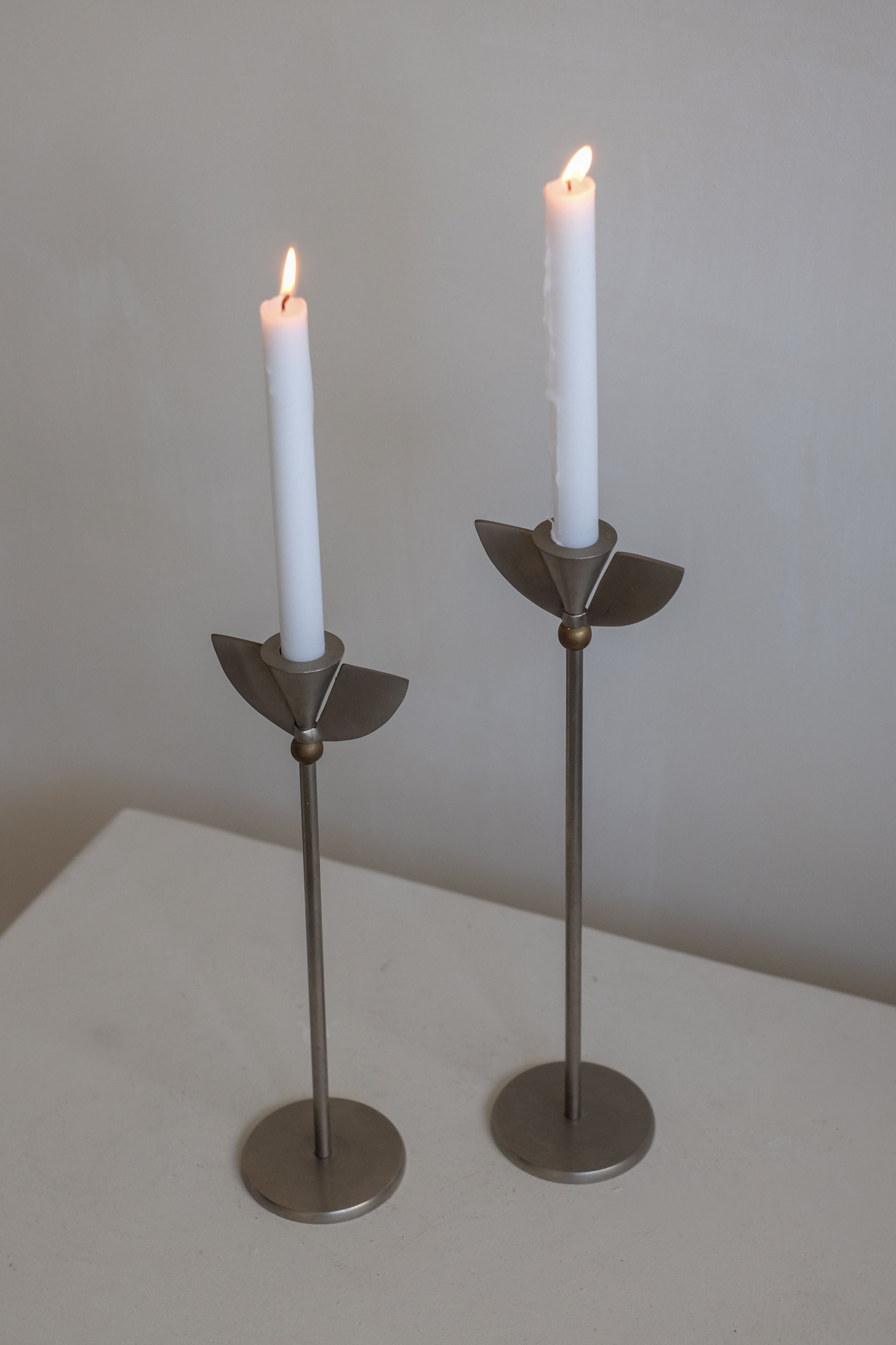 Set of 2 Memphis Candleholders — standing on light-colored table with white candles