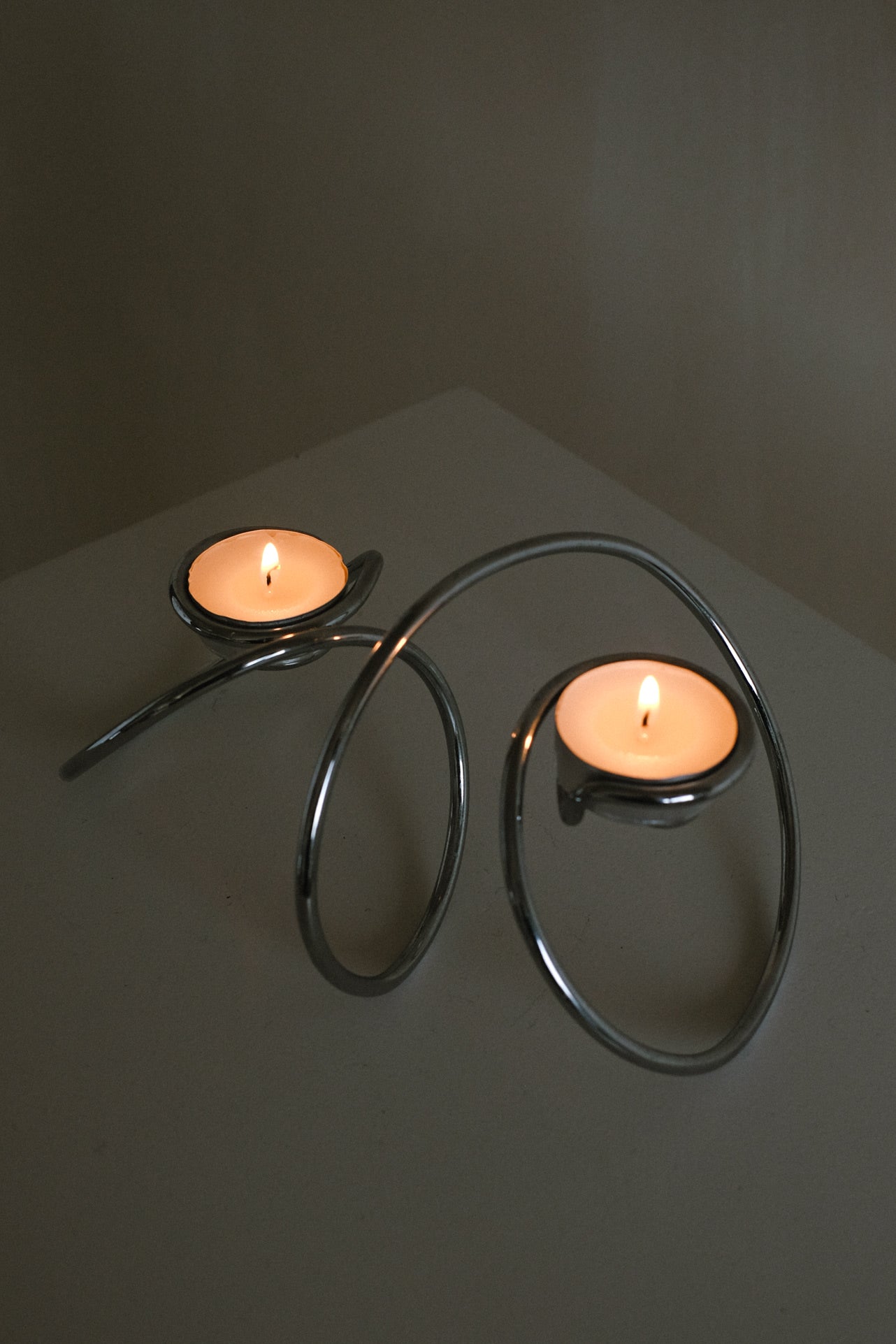 Chrome Candleholder — back view showing curved chrome design with candles