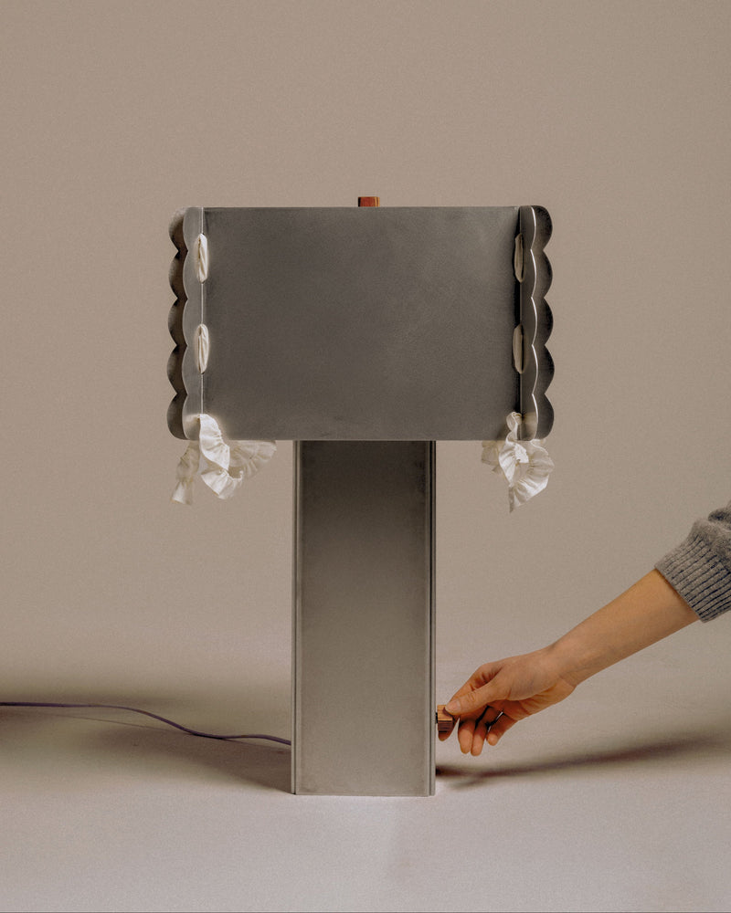 Hand activating scalloped-edge Serwetka table lamp with pleated shade