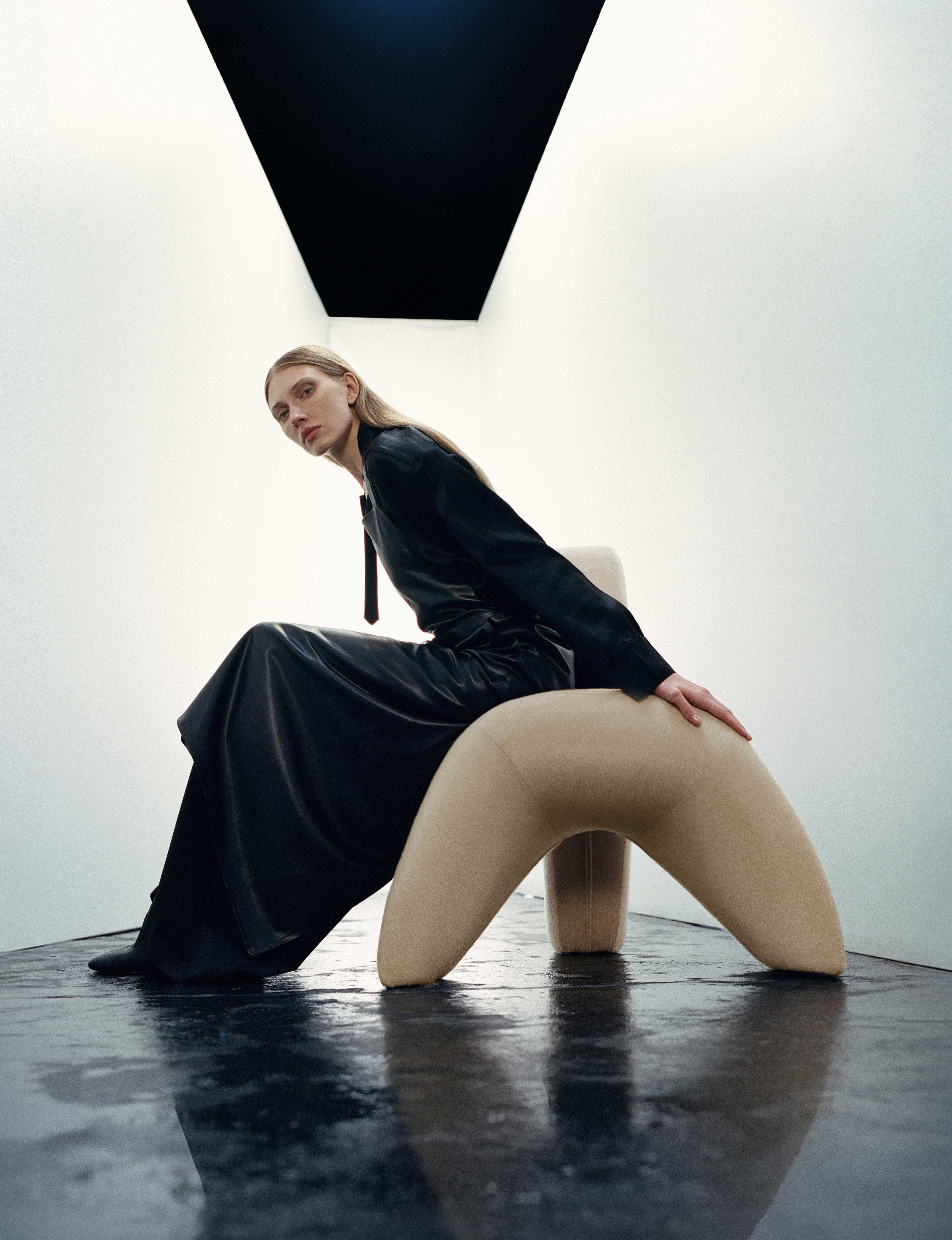 Sokil armchair — side view highlighting beige upholstery and modern design
