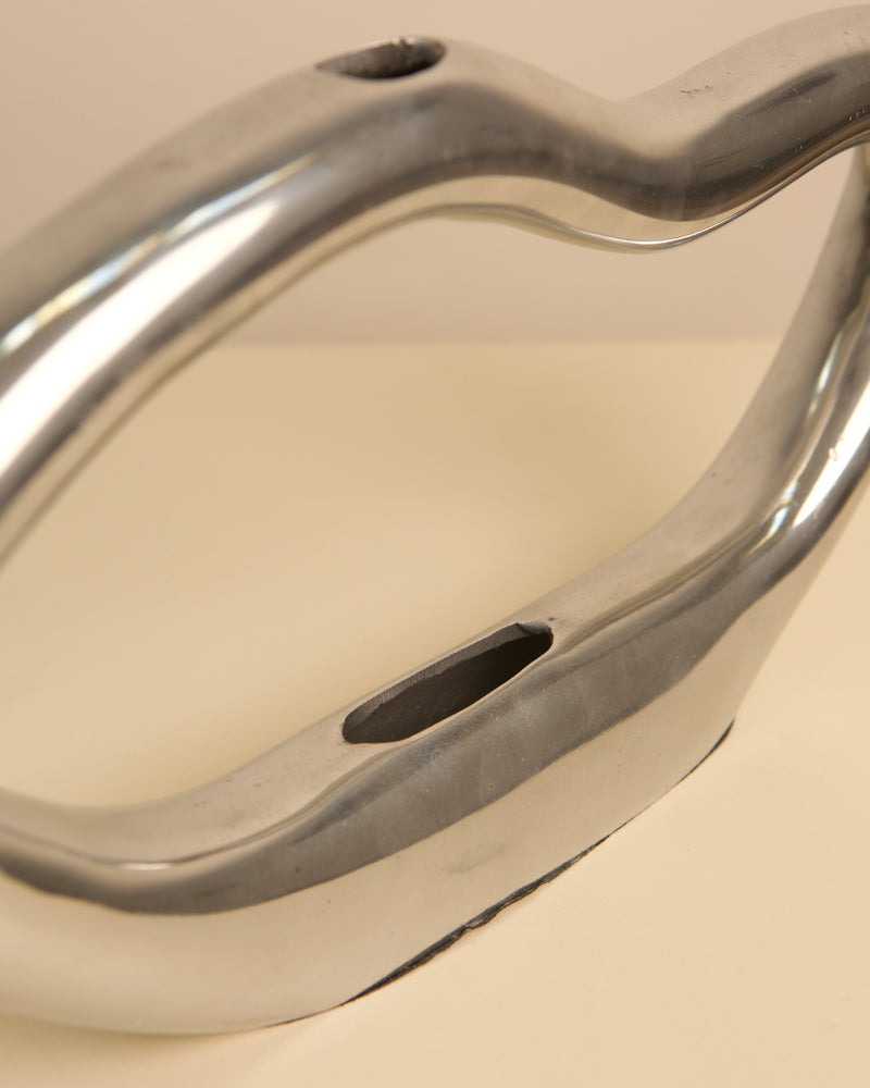 Curved metallic Onde vase detail showing organic wave-like form
