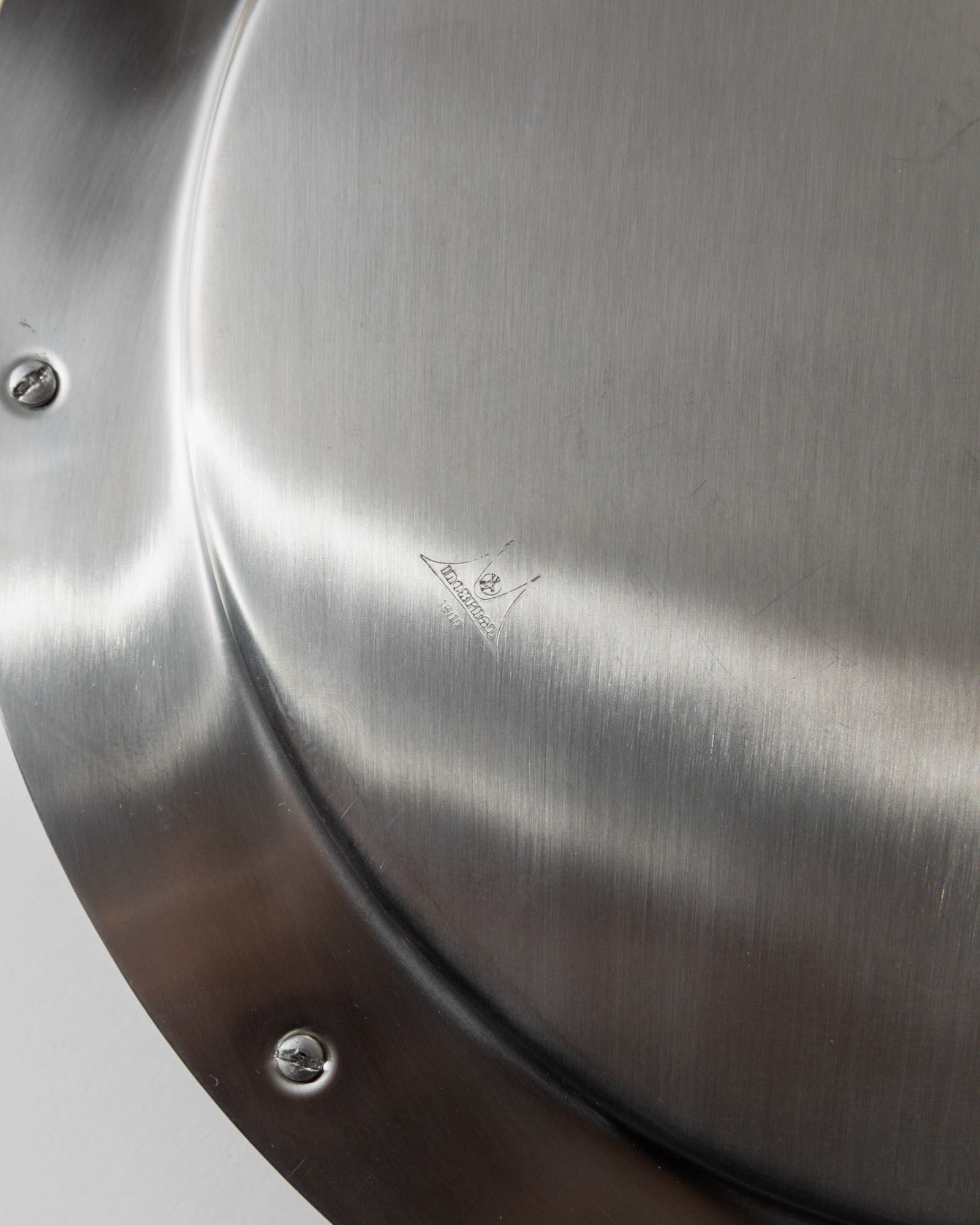 Vintage 1980s Stainless Steel Tray round, close-up of brushed surface