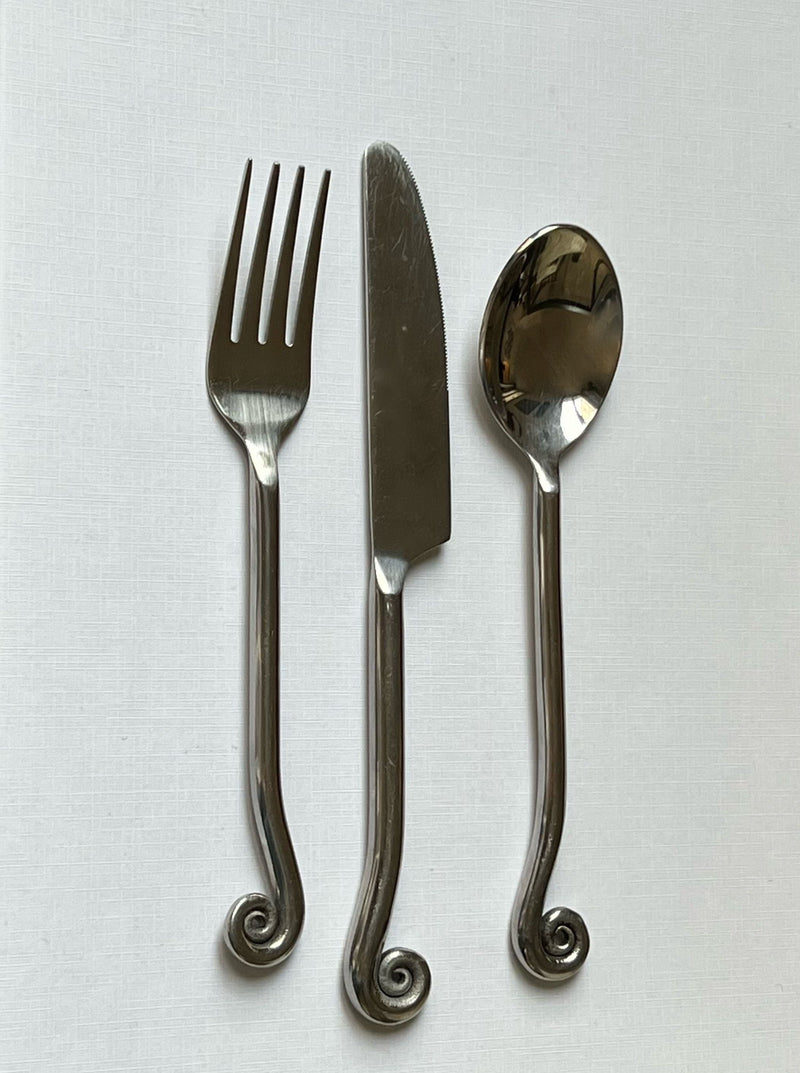 Vintage stainless steel cutlery set with decorative swirl handles