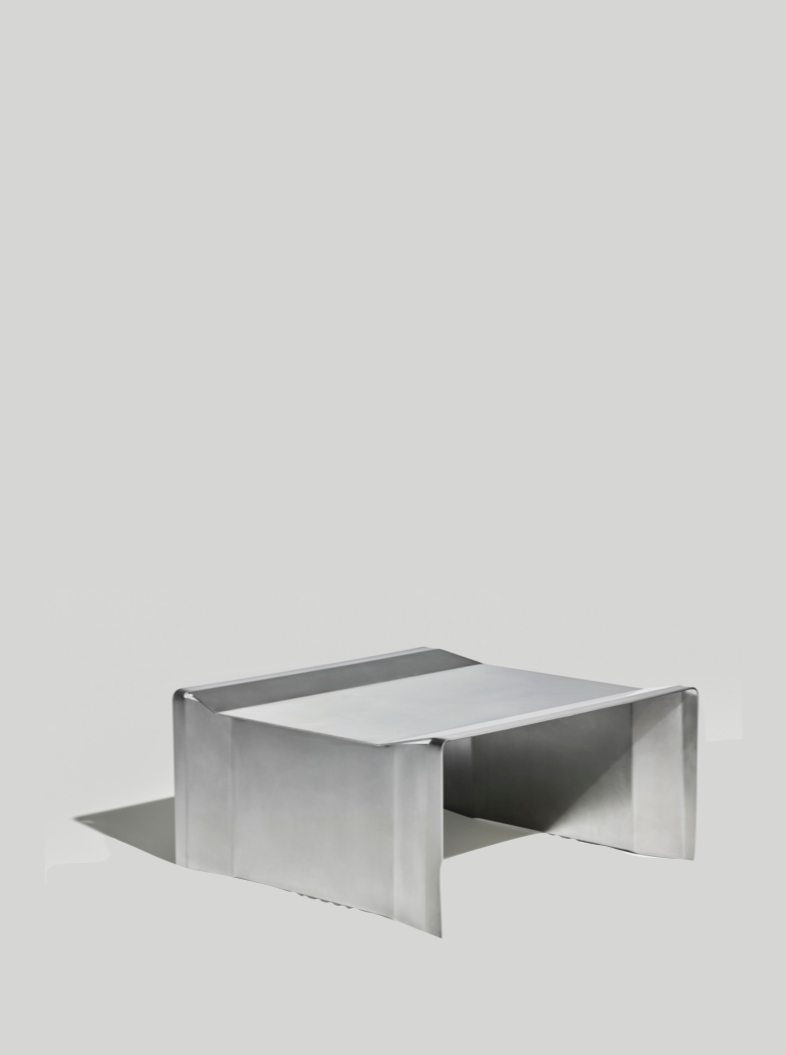 Camber stainless steel coffee table with geometric curved design