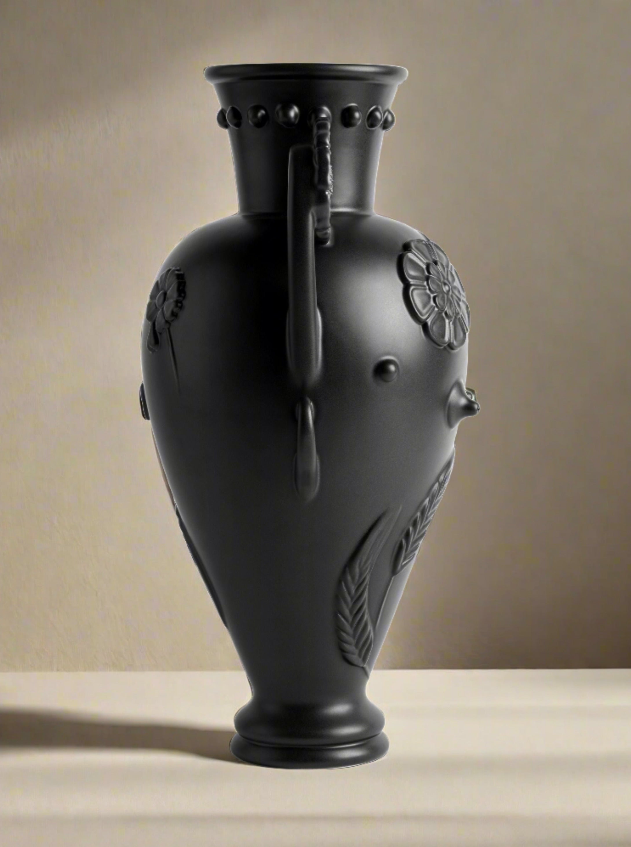 Black Earthenware Vase — close-up of textured black surface with floral design
