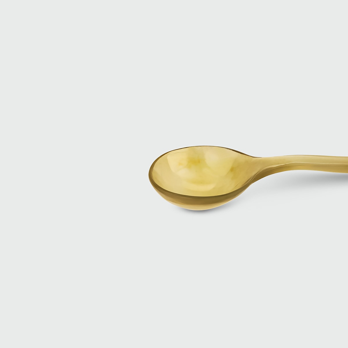 Ossu Nude Spoon — angled view highlighting brass material