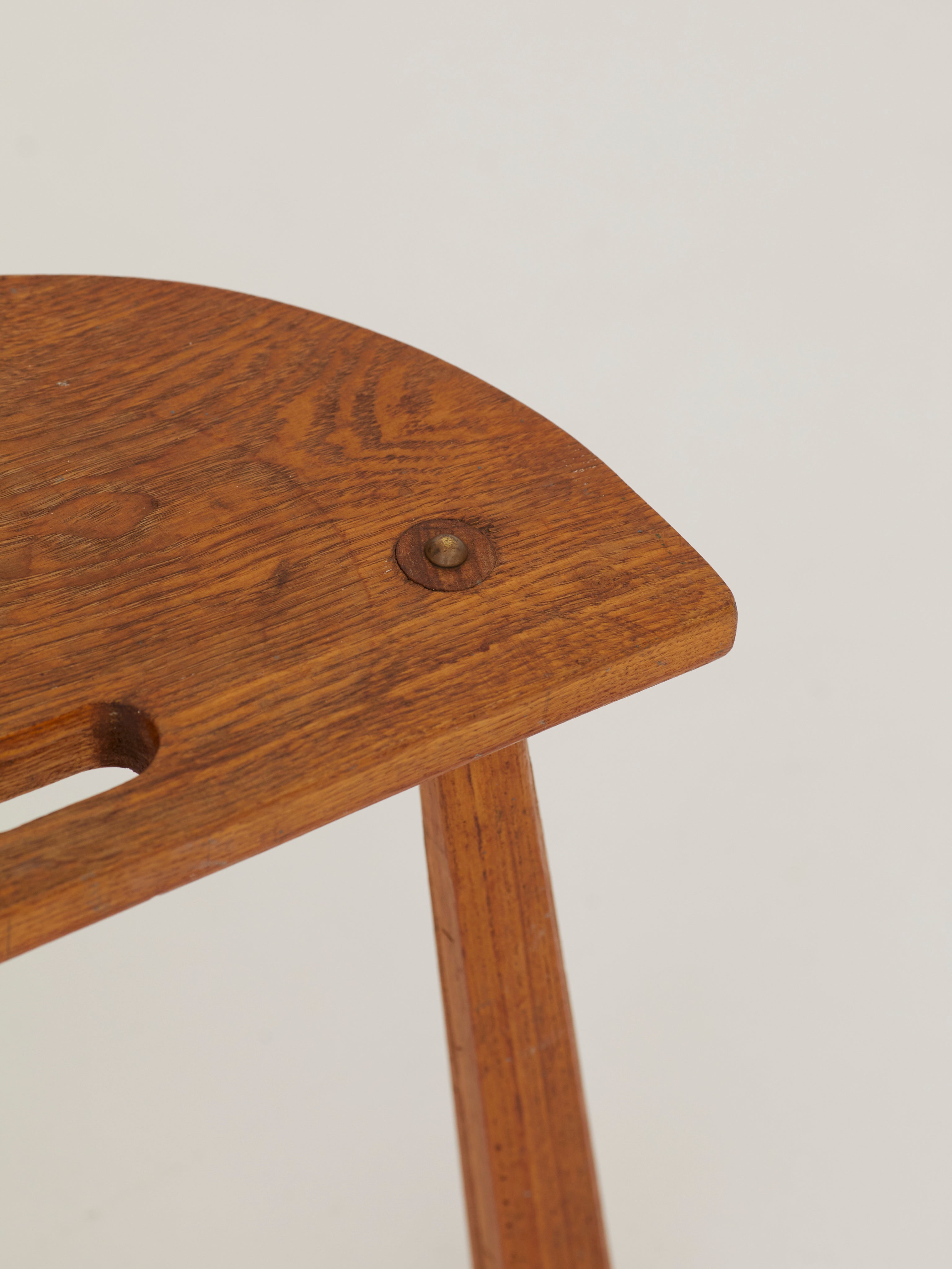 Two French Artisanal Solid Wood Half-moon Tripod Stools, Circa 1950 — top view of wooden seat with visible grain