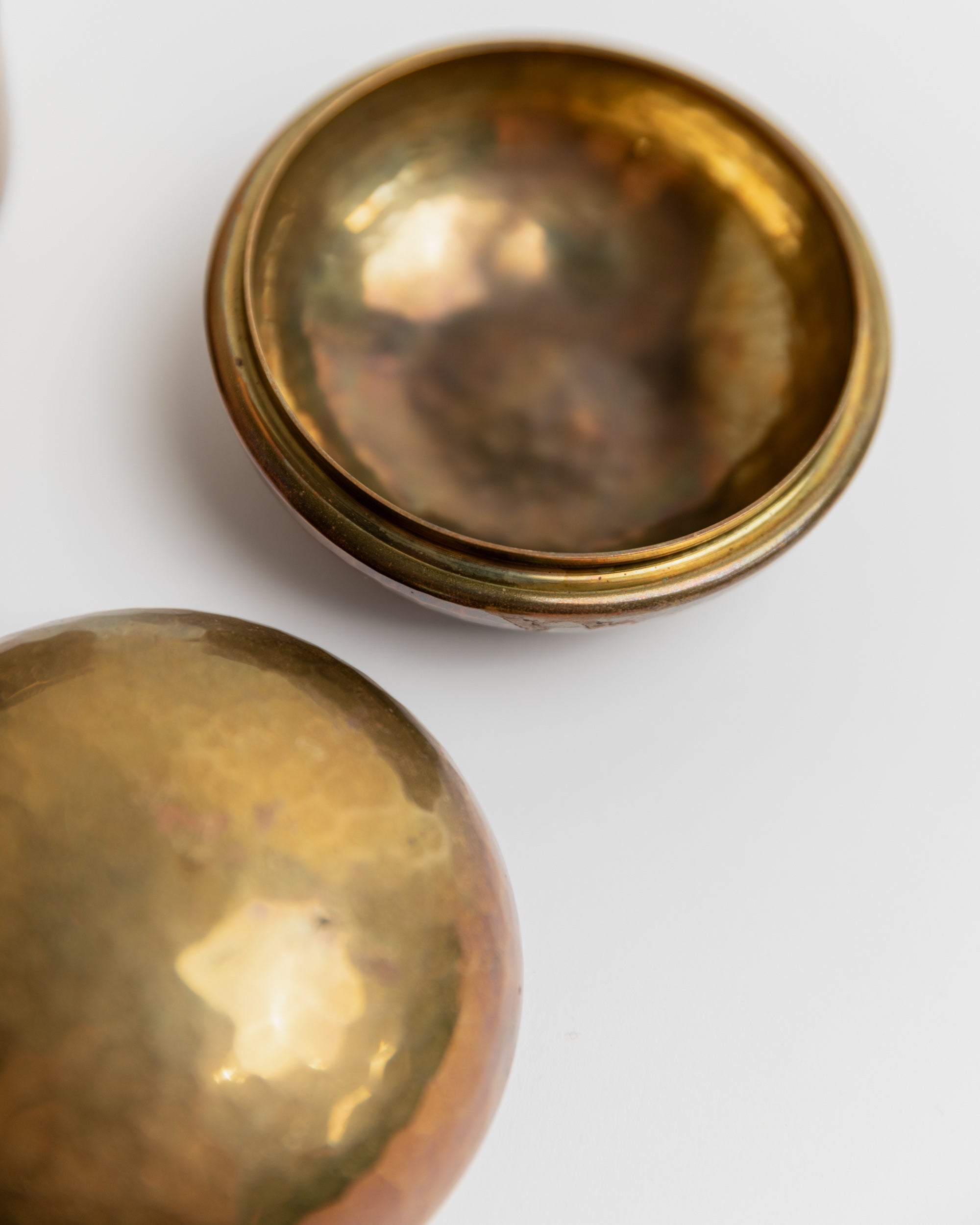 Interior view of vintage brass tins showing polished golden surface