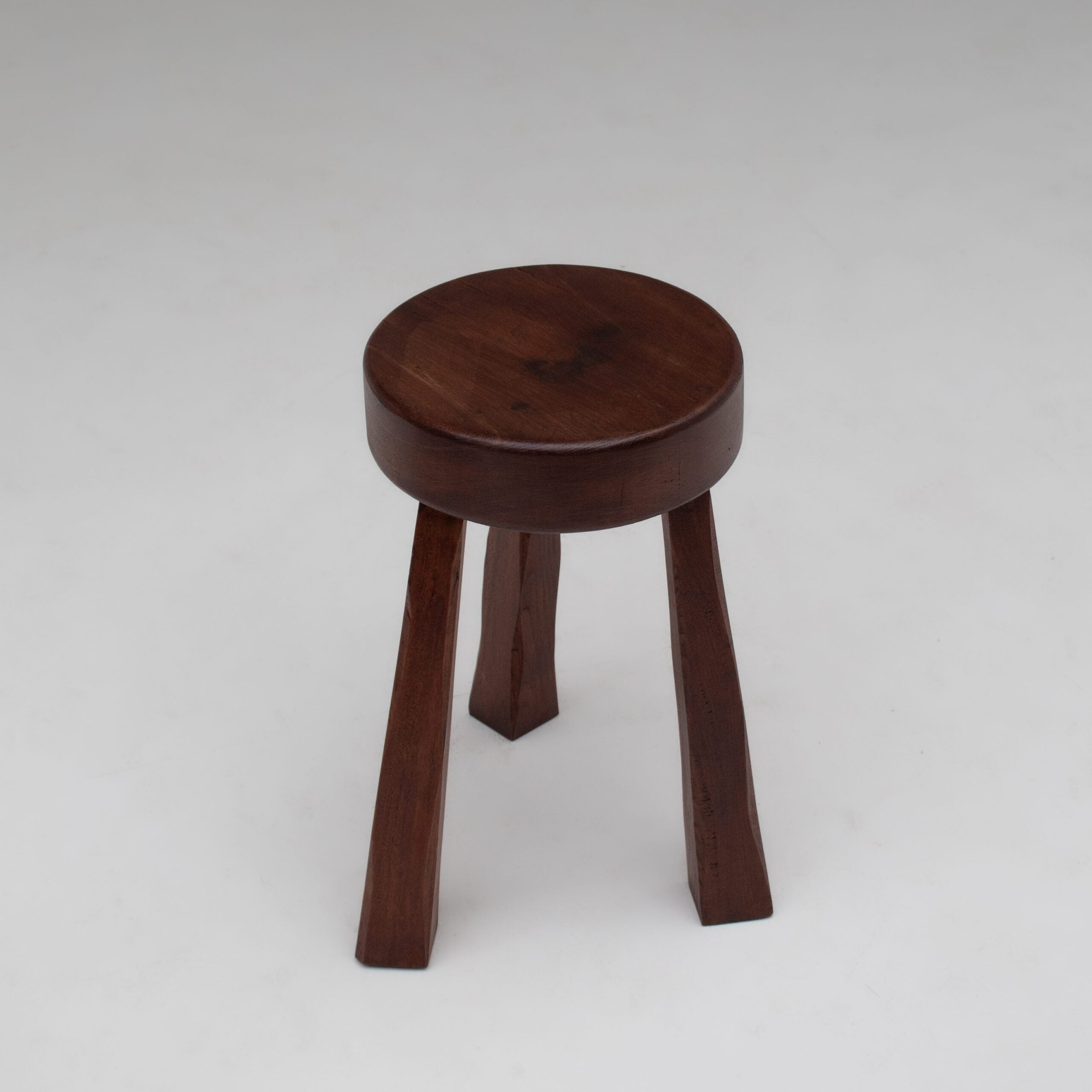 Round Wooden Stool — close-up of dark wood finish and legs