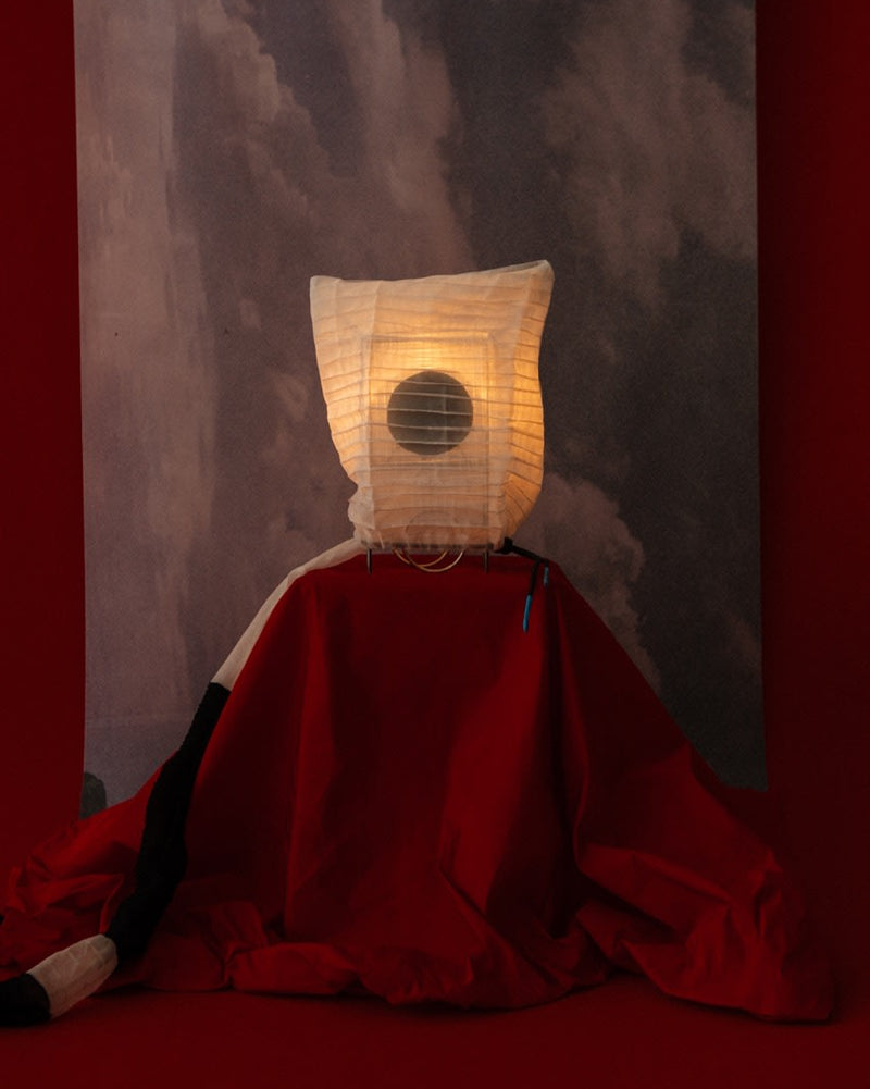 Majo table lamp with illuminated paper shade and red fabric base