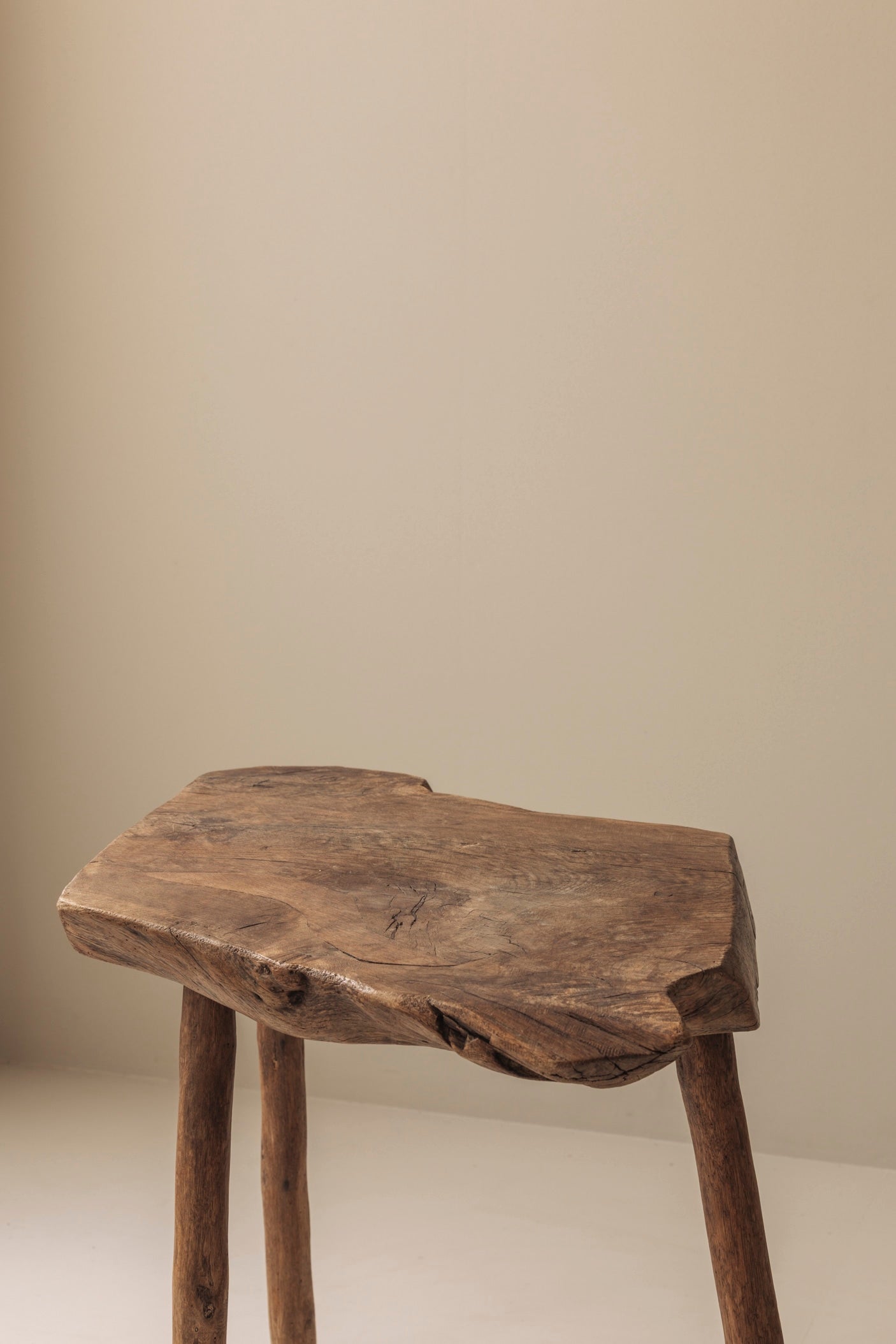 Sculptural French tripod side table in solid elm dating from the 1950s. — lifestyle setting