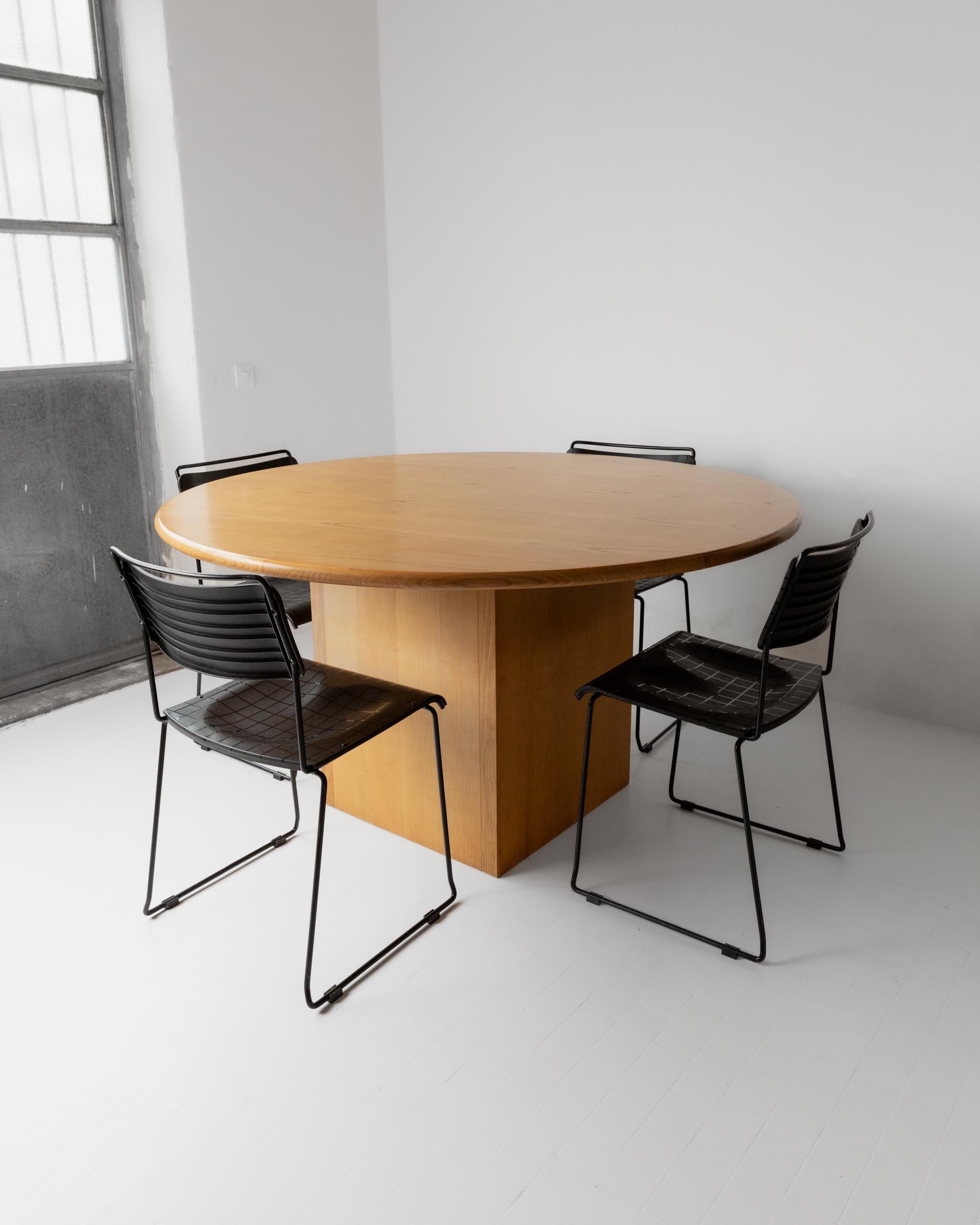 1980s Large Round Wooden Table — top view with four black chairs