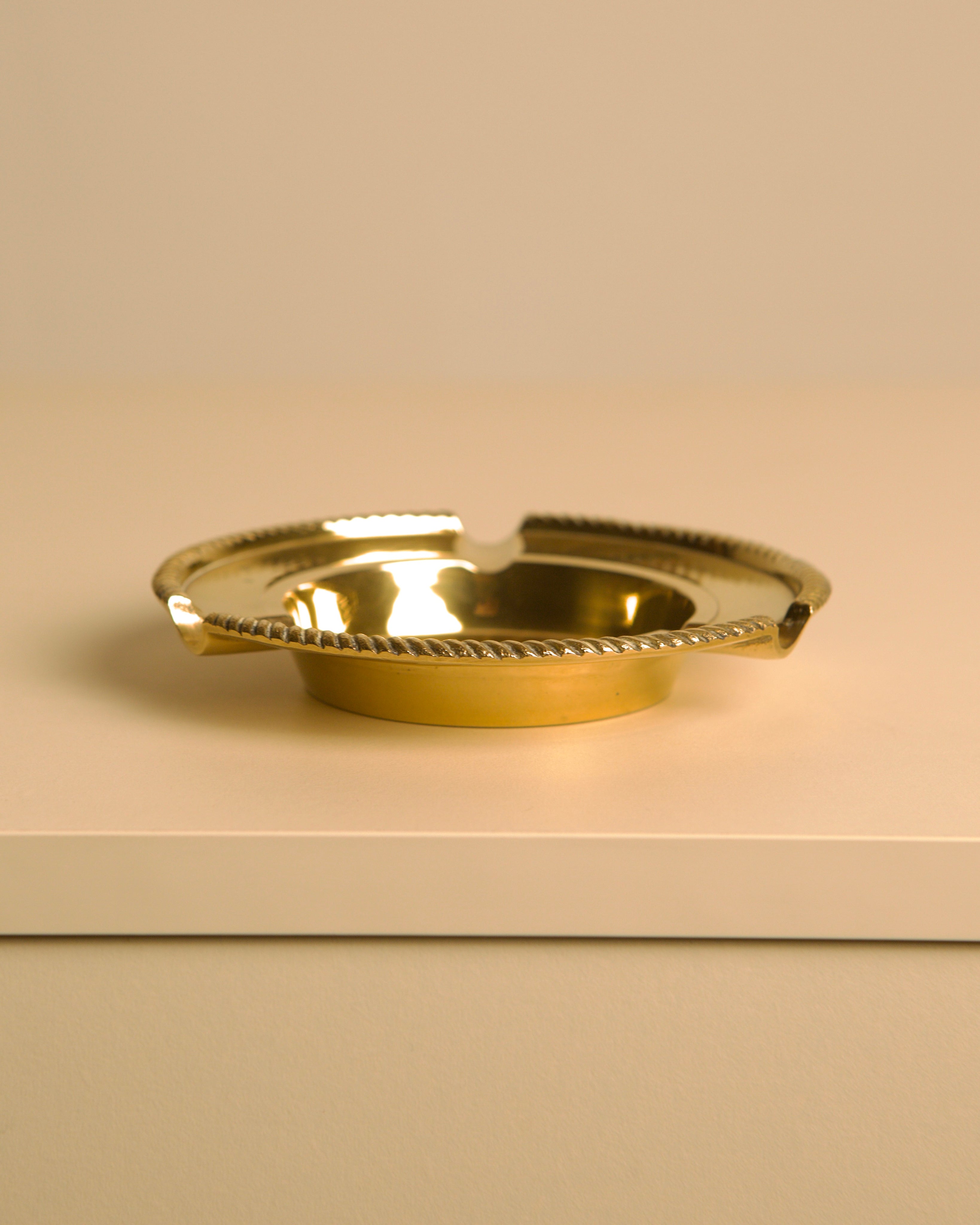 Italian Brass Ashtray DLG Jean Després 60's — side angle on white surface