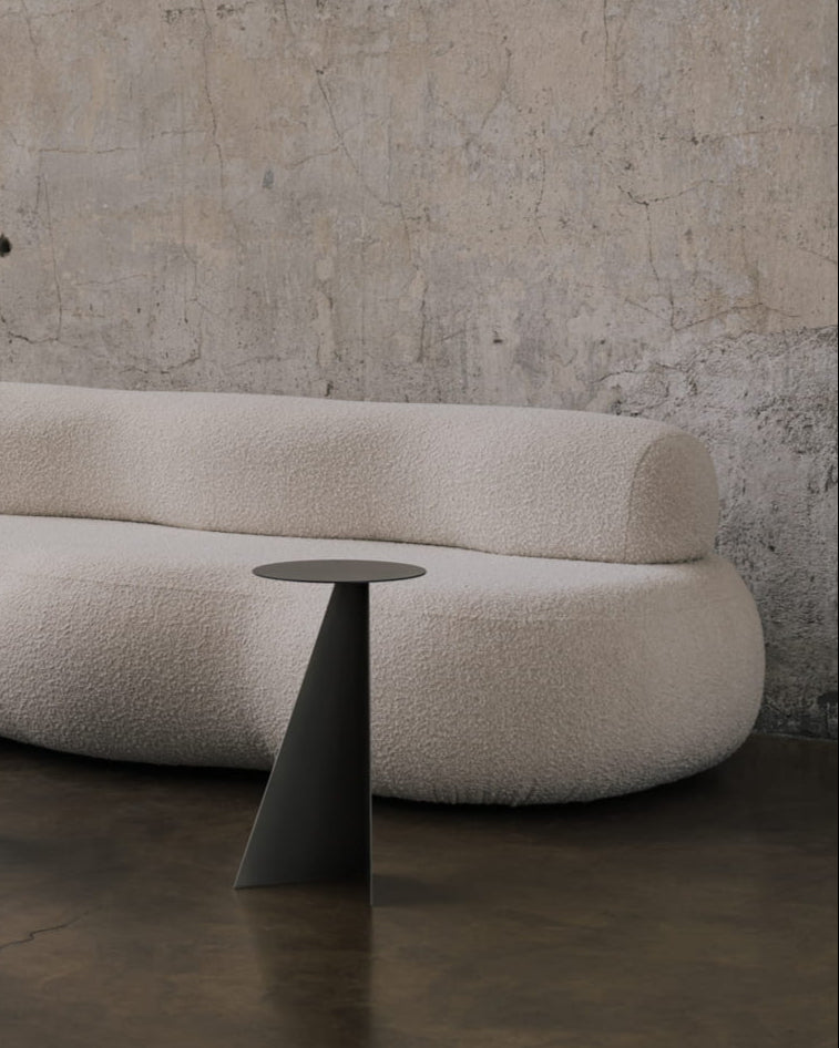 Aluminum Side Table Object084 — side angle against textured wall and sofa
