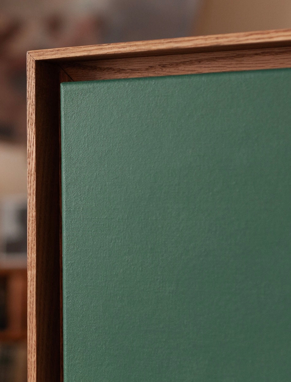 Prism — close-up of green canvas in wooden frame
