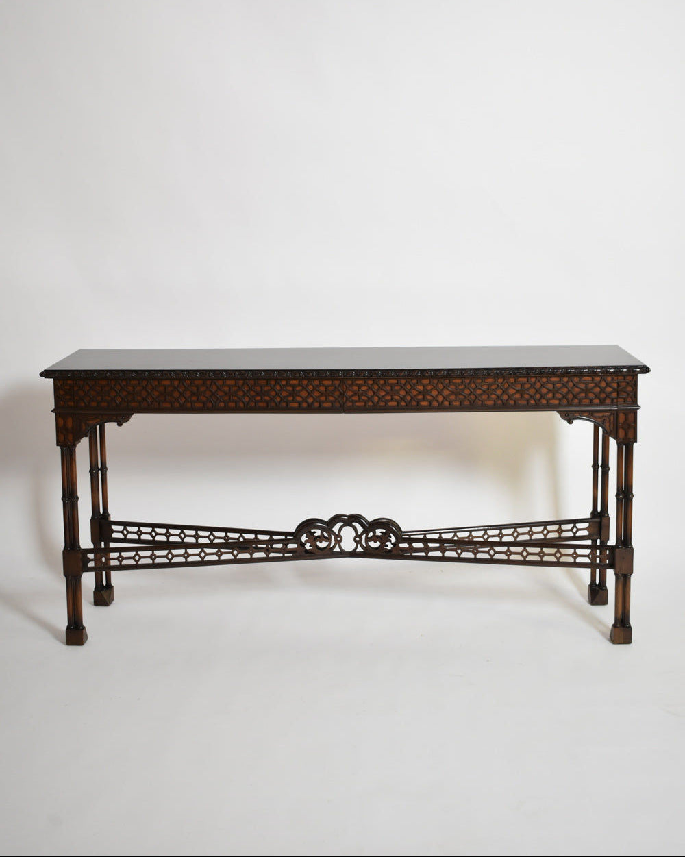 The Carved Wood Console Table, XIXth c. by Barracuda Interiors features intricate latticework and decorative patterns on a long rectangular frame, evoking classic elegance against a plain white background.