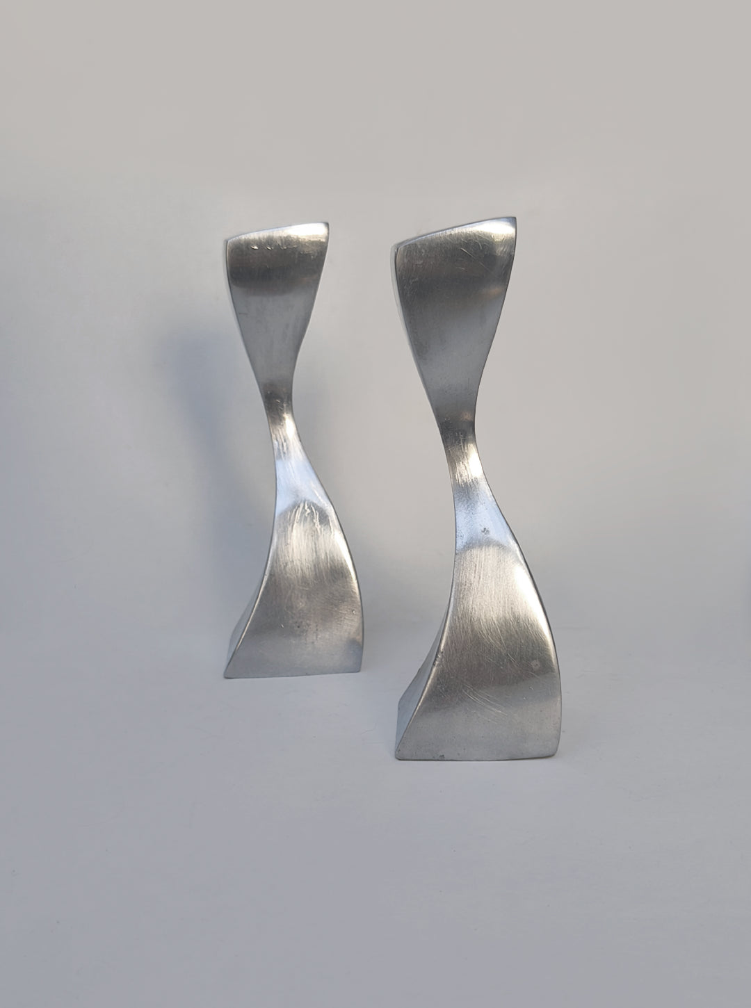 Twisted Candle Holders — close-up of polished metal surface
