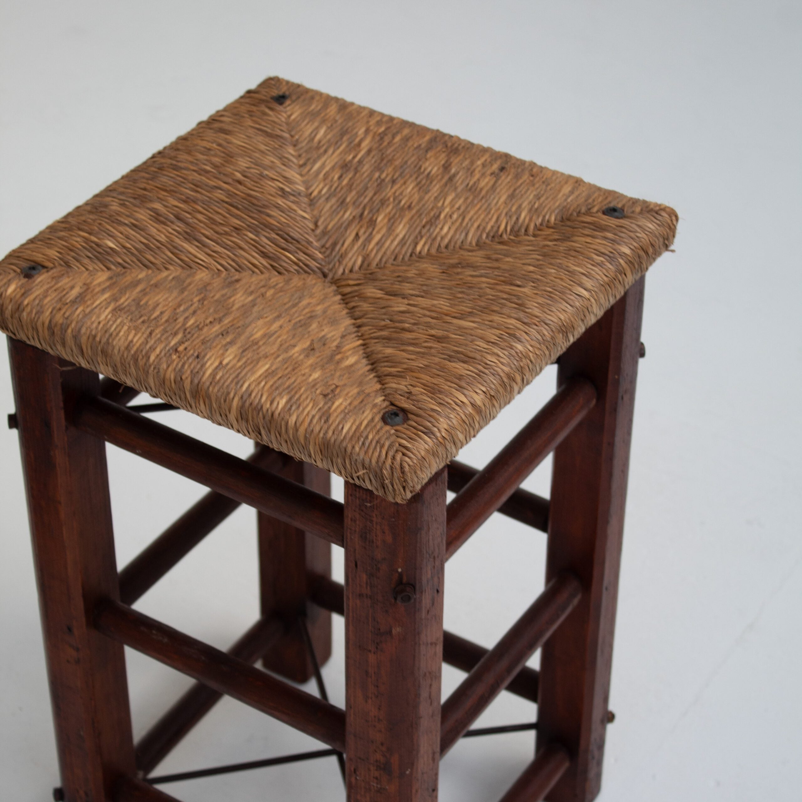 Pair of Rustic Wooden Stools with Woven Rush Seats — top view of woven rush seat