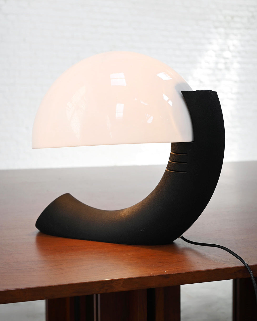 Curved black base of Italian Concordia table lamp with dome shade