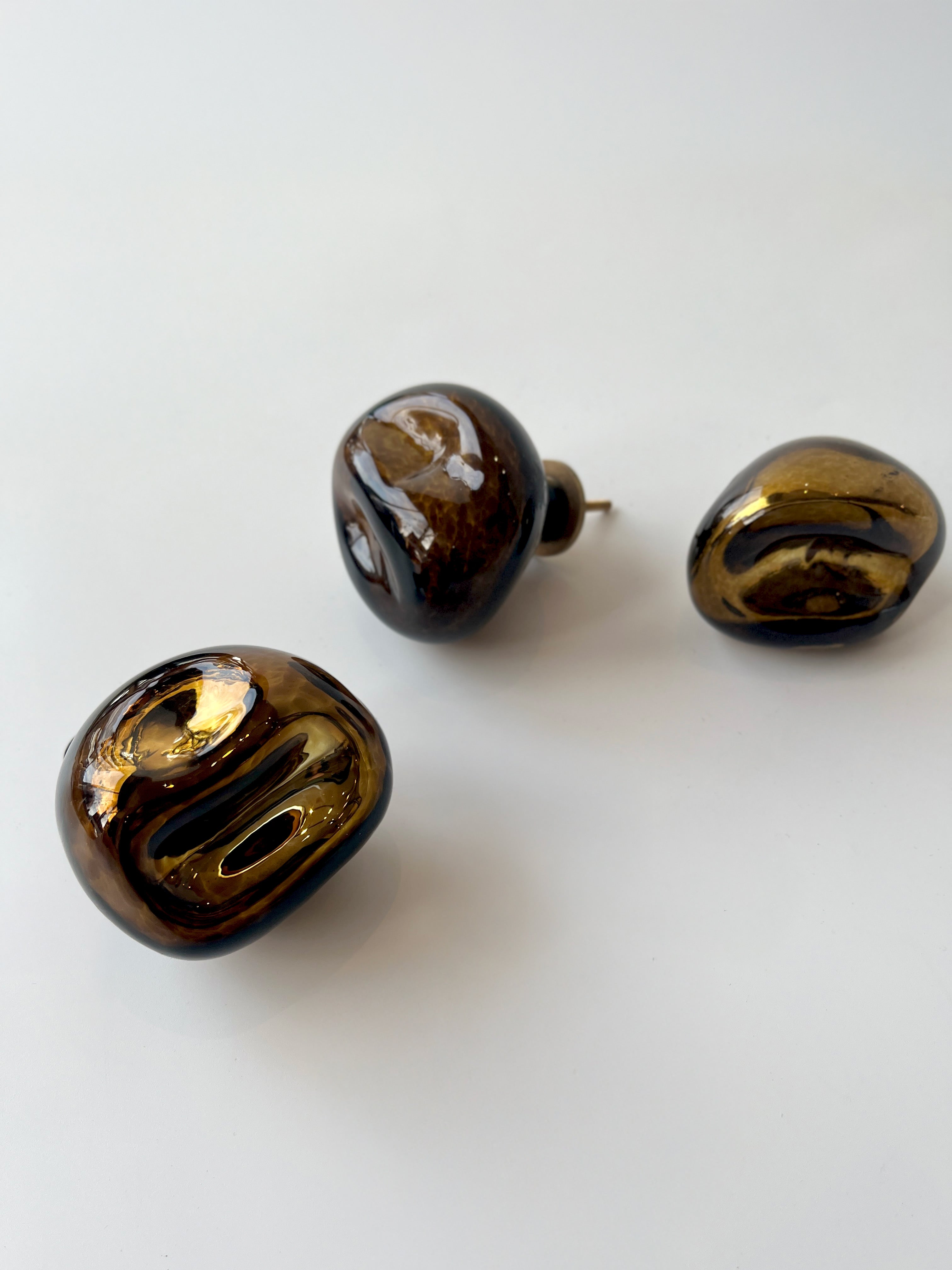 Knobs Collection Sculptures in Glass — three glass knobs on white surface