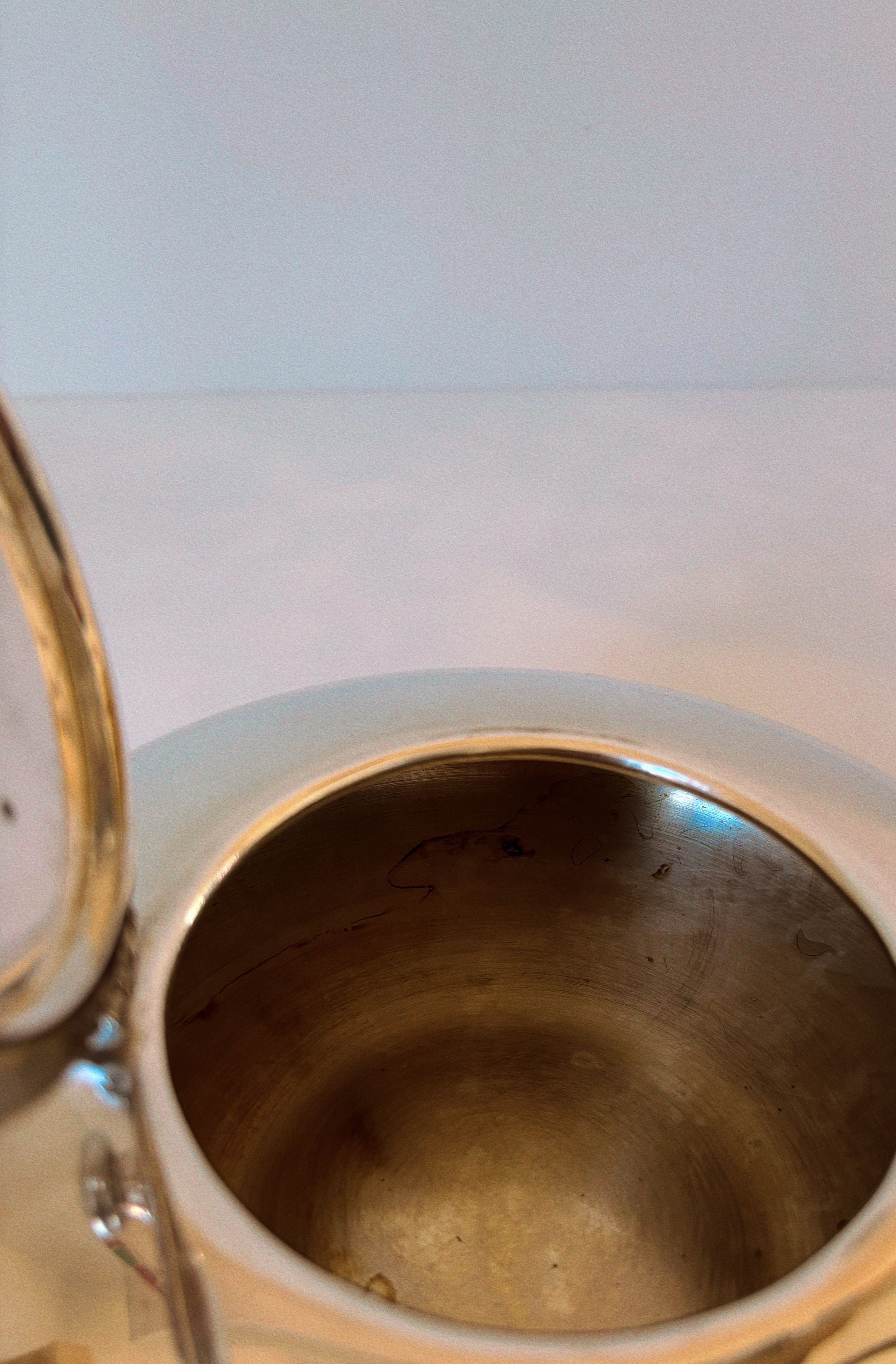 Interior view of vintage Swedish silver plated teapot showing craftsmanship
