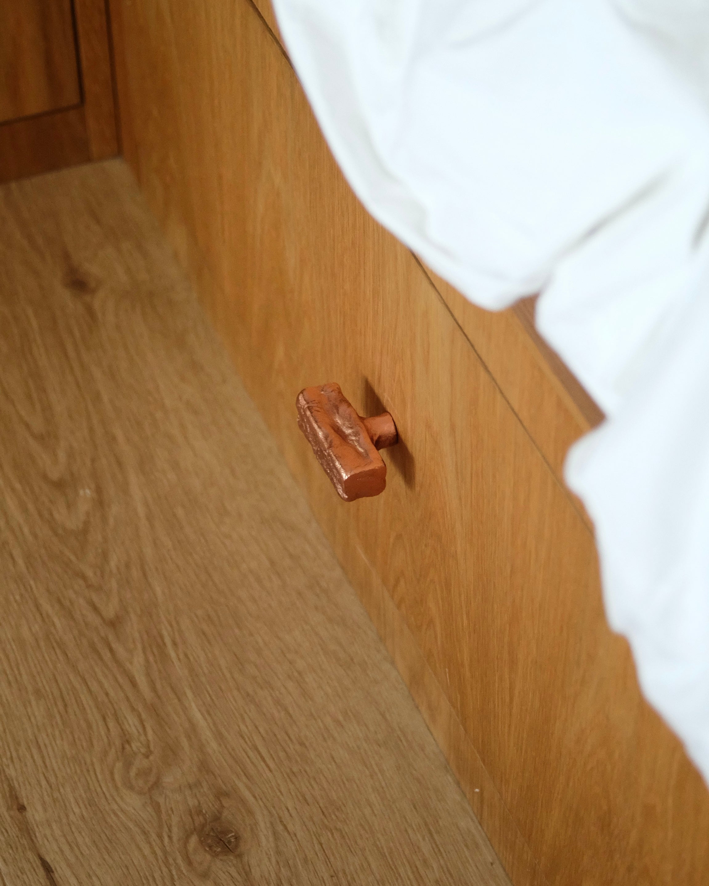 ISLE Cabinet Knob/Wall Hook Medium — side view on wooden cabinet