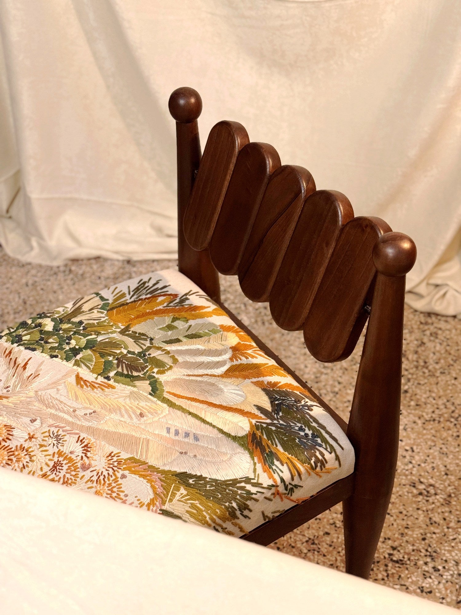 SIMORGH II – Solid Walnut with Hand-Embroidered Upholstery — side angle showing detailed upholstery pattern